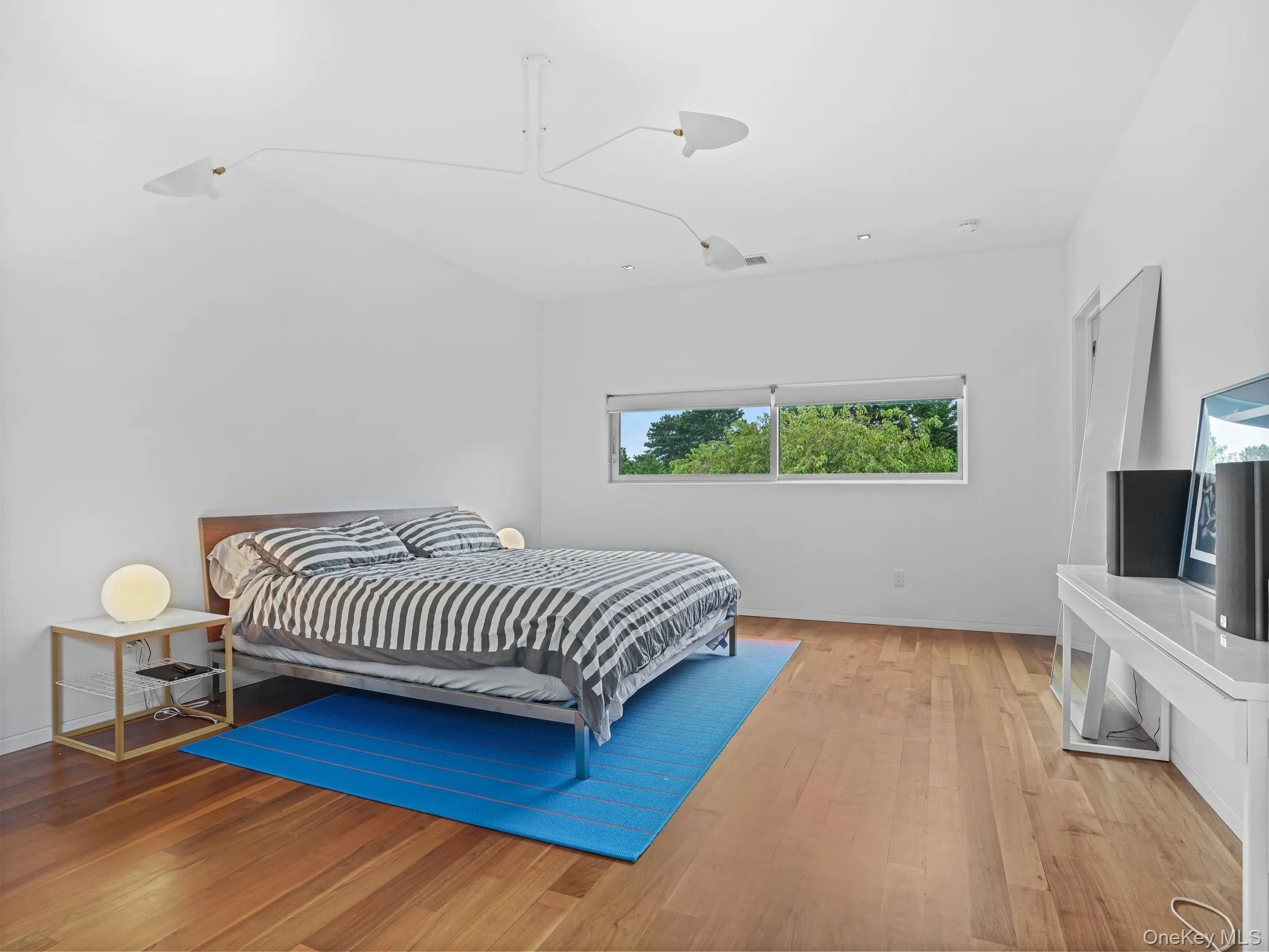 Bedroom with wood finished floors and baseboards Bedroom with wood finished floors and baseboards