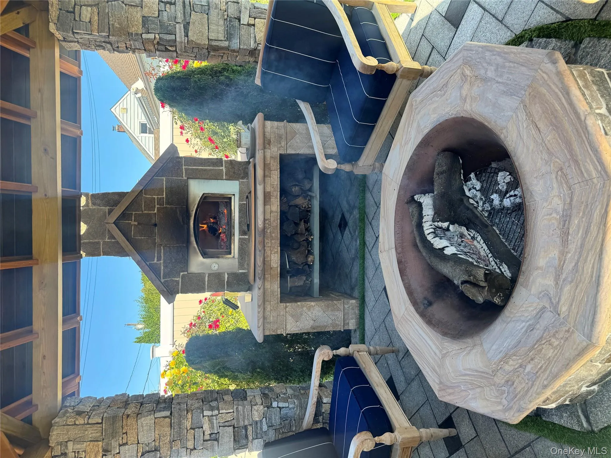 View of patio featuring an outdoor stone fireplace View of patio featuring an outdoor stone fireplace