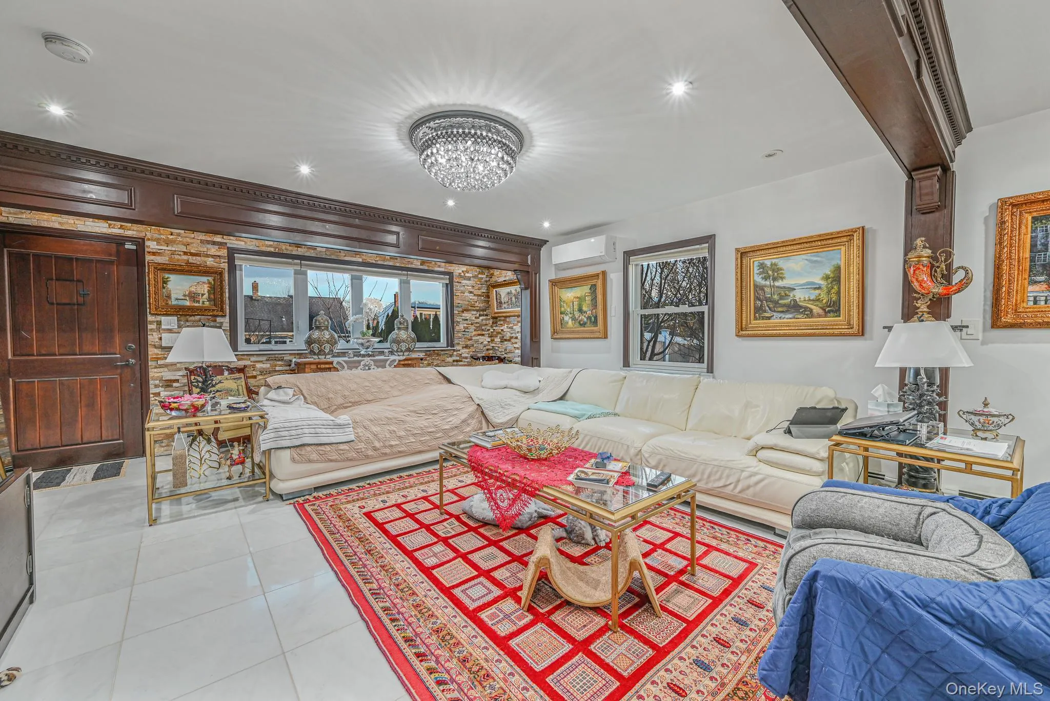Living room featuring light tile patterned floors, a chandelier, a wall mounted air conditioner, and recessed lighting Living room featuring light tile patterned floors, a chandelier, a wall mounted air conditioner, and recessed lighting
