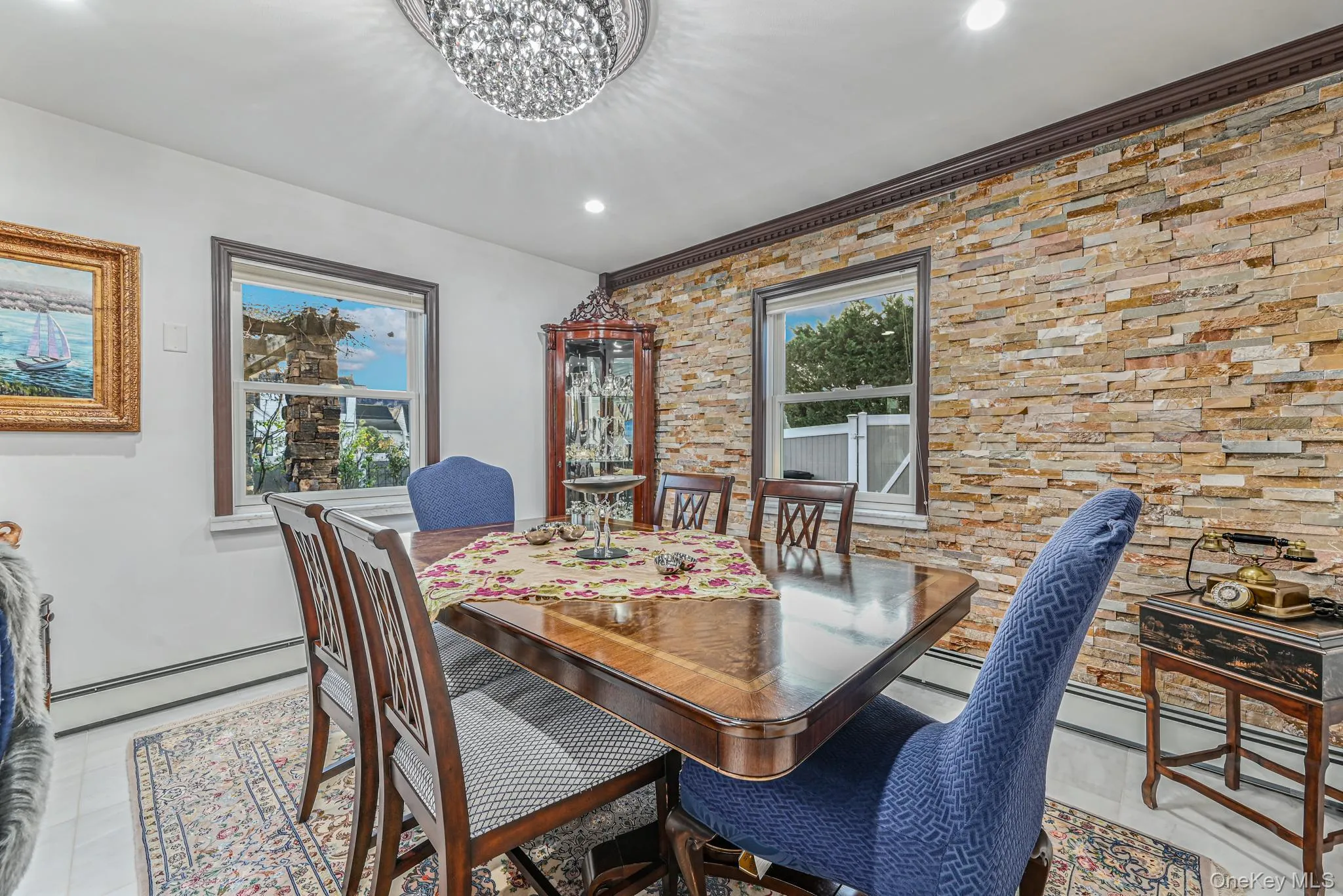 Dining area featuring a baseboard heating unit, a chandelier, recessed lighting, and a baseboard radiator Dining area featuring a baseboard heating unit, a chandelier, recessed lighting, and a baseboard radiator