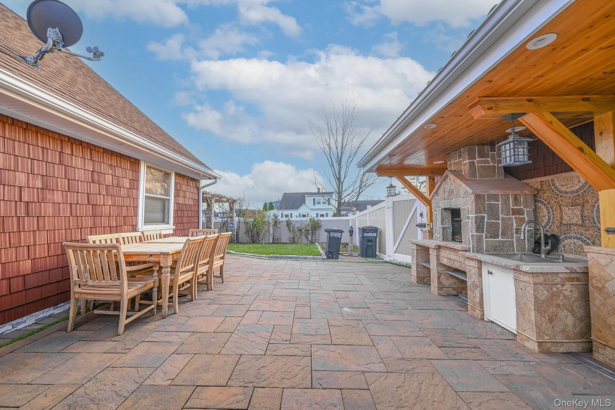 Fenced backyard featuring a patio area and outdoor dining area Fenced backyard featuring a patio area and outdoor dining area