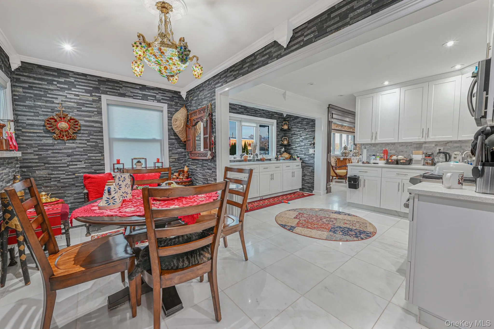 Dining room with ornamental molding, plenty of natural light, recessed lighting, light tile patterned floors, and a chandelier Dining room with ornamental molding, plenty of natural light, recessed lighting, light tile patterned floors, and a chandelier