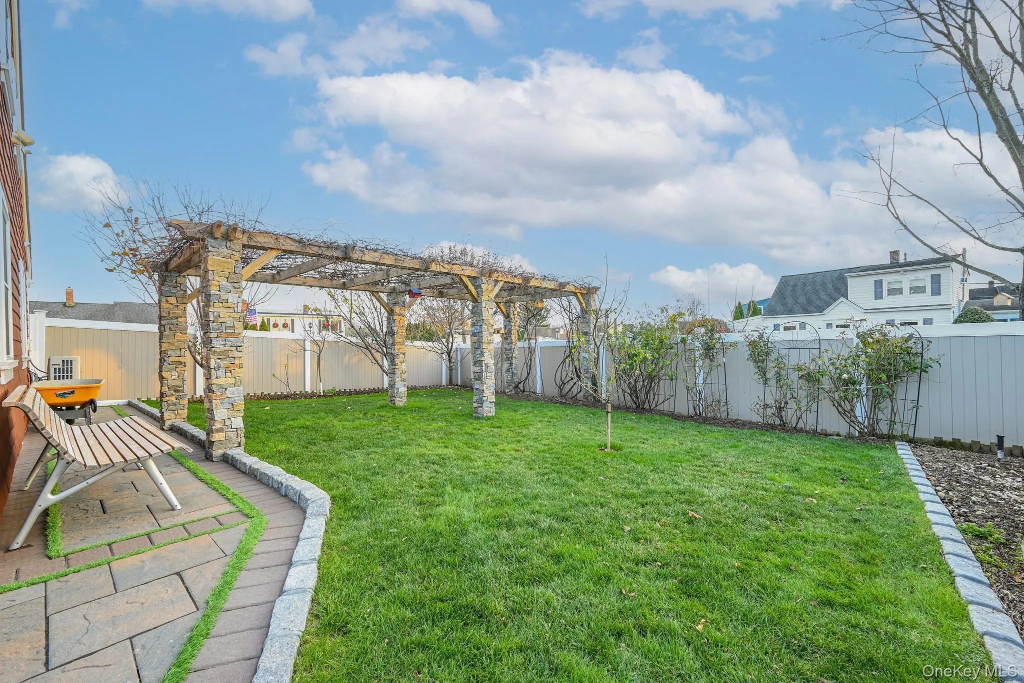 Fenced backyard with a patio area Fenced backyard with a patio area