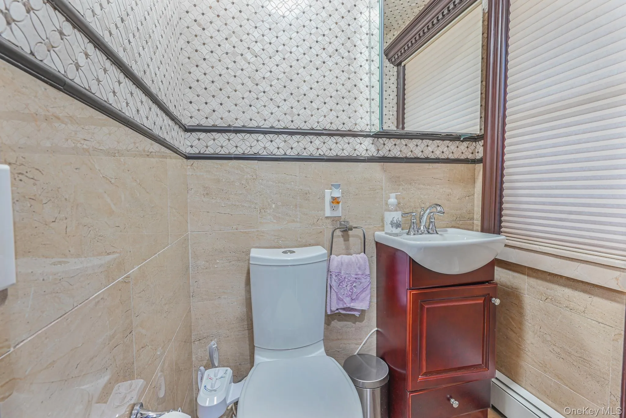 Half bath featuring vanity and tile walls Half bath featuring vanity and tile walls