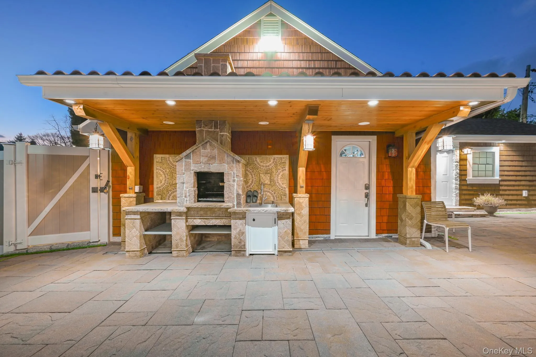 Porch with an outdoor stone fireplace and a gate Porch with an outdoor stone fireplace and a gate