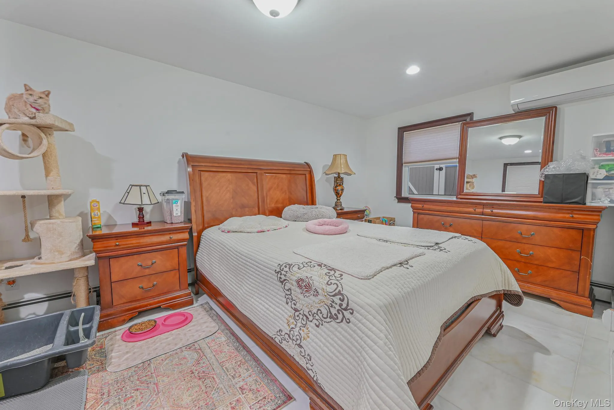 Bedroom with a wall unit AC and recessed lighting Bedroom with a wall unit AC and recessed lighting