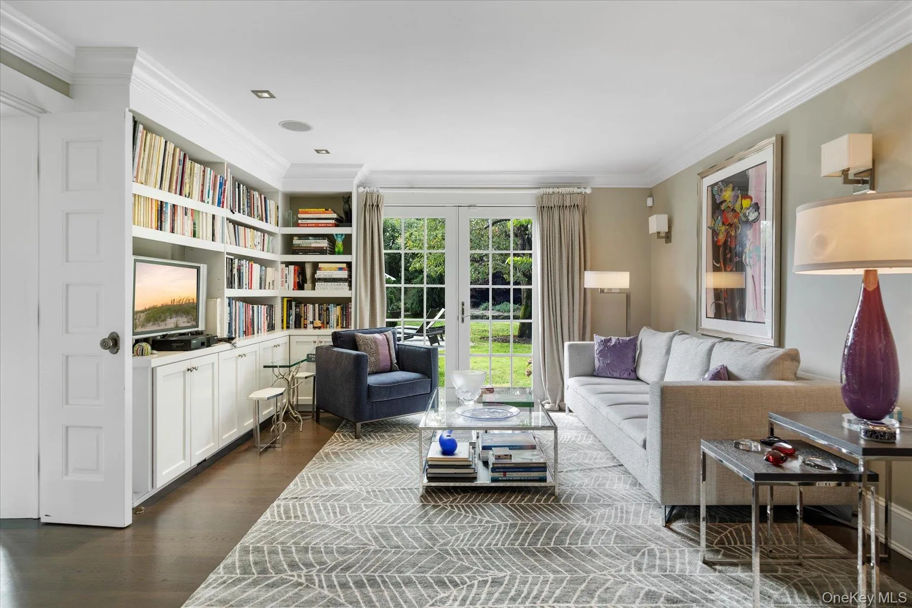 Sitting room with crown molding, dark wood-style flooring, and french doors Sitting room with crown molding, dark wood-style flooring, and french doors