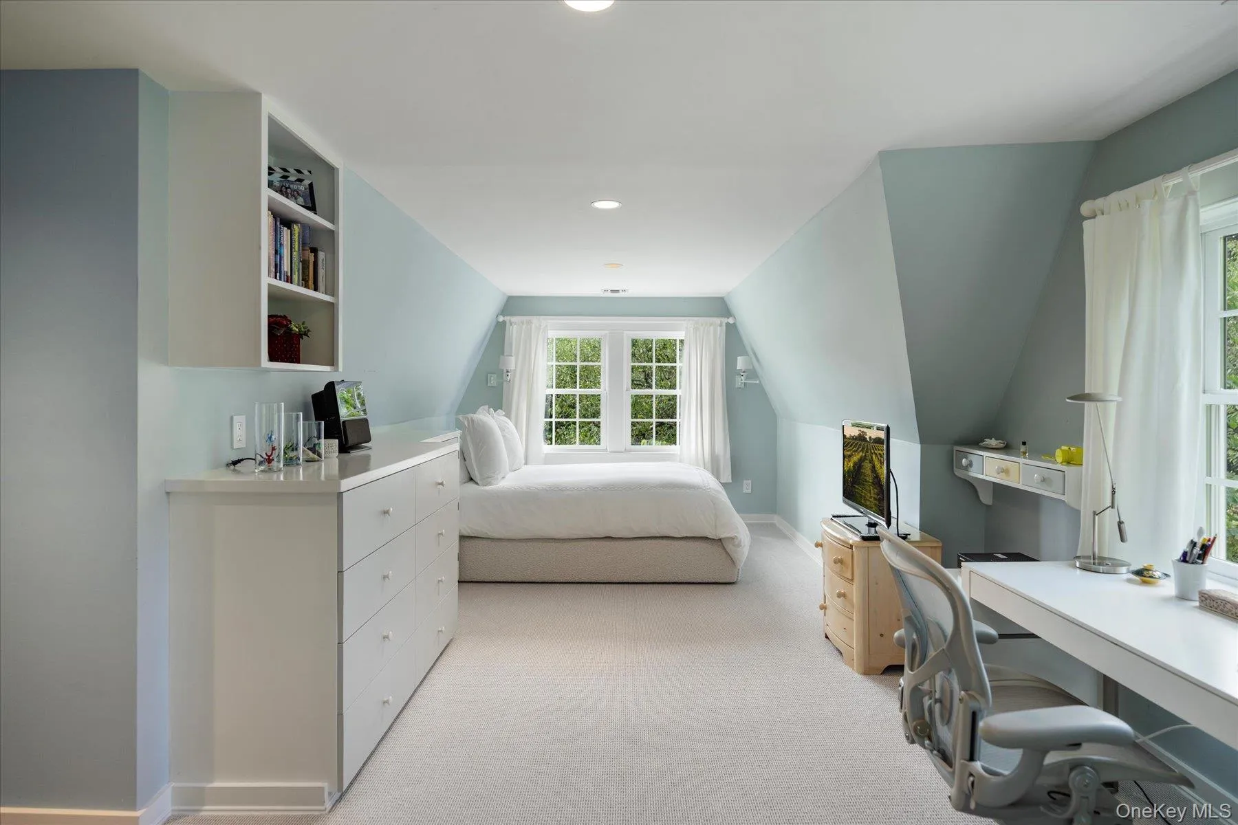 Bedroom featuring light carpet, lofted ceiling, an office area, and recessed lighting Bedroom featuring light carpet, lofted ceiling, an office area, and recessed lighting