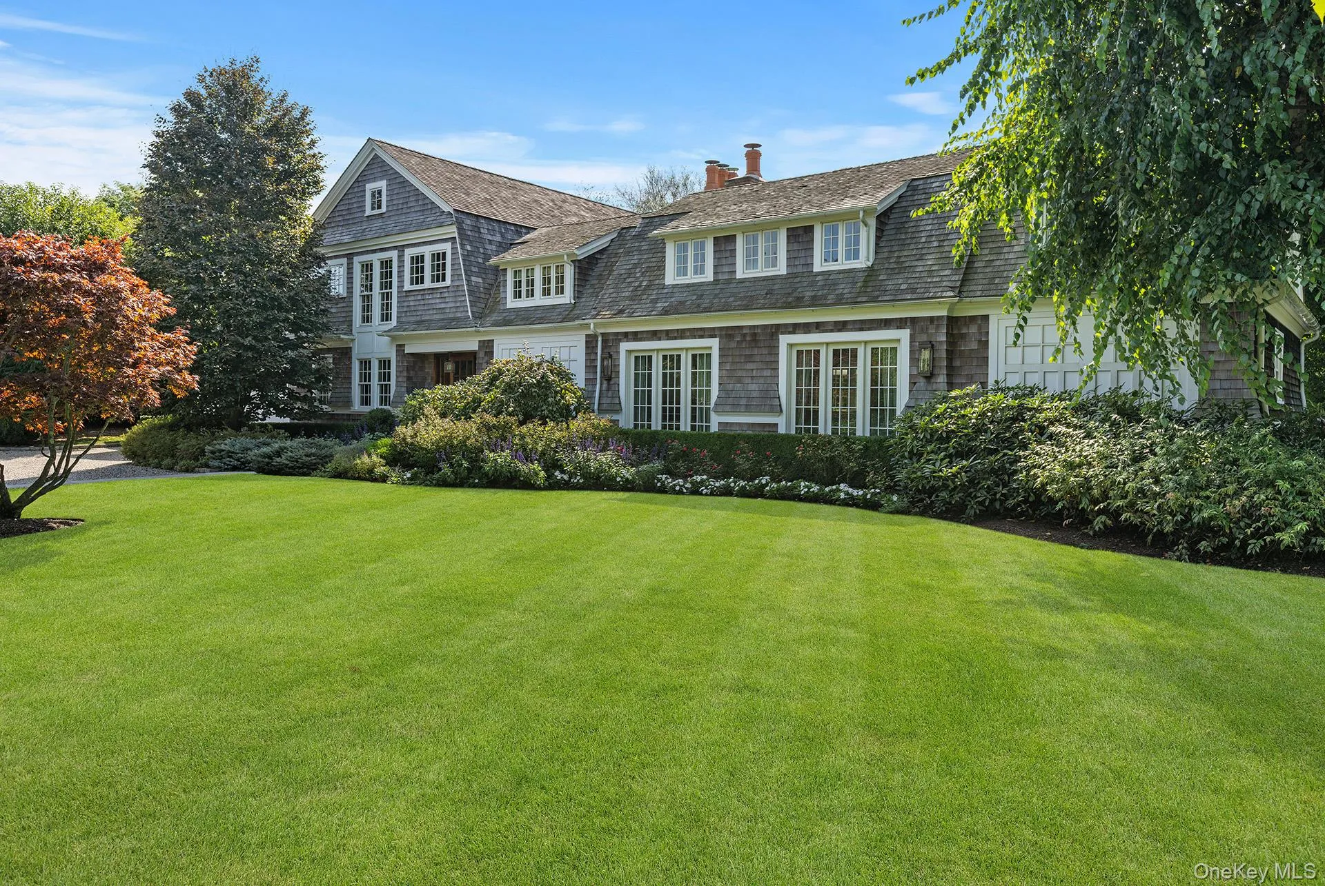 View of front of home with a chimney and a front lawn View of front of home with a chimney and a front lawn