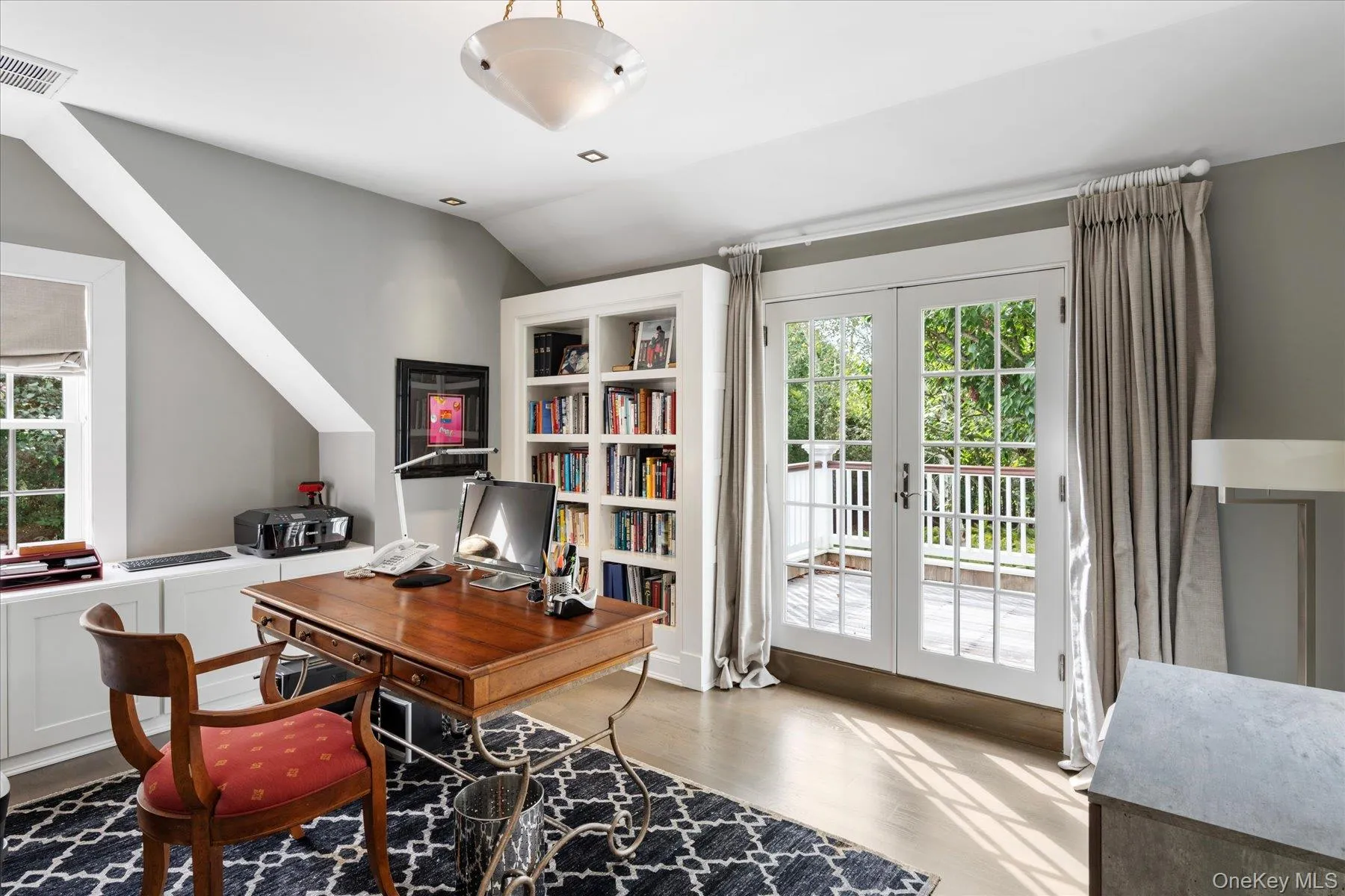 Home office with french doors, wood finished floors, and lofted ceiling Home office with french doors, wood finished floors, and lofted ceiling