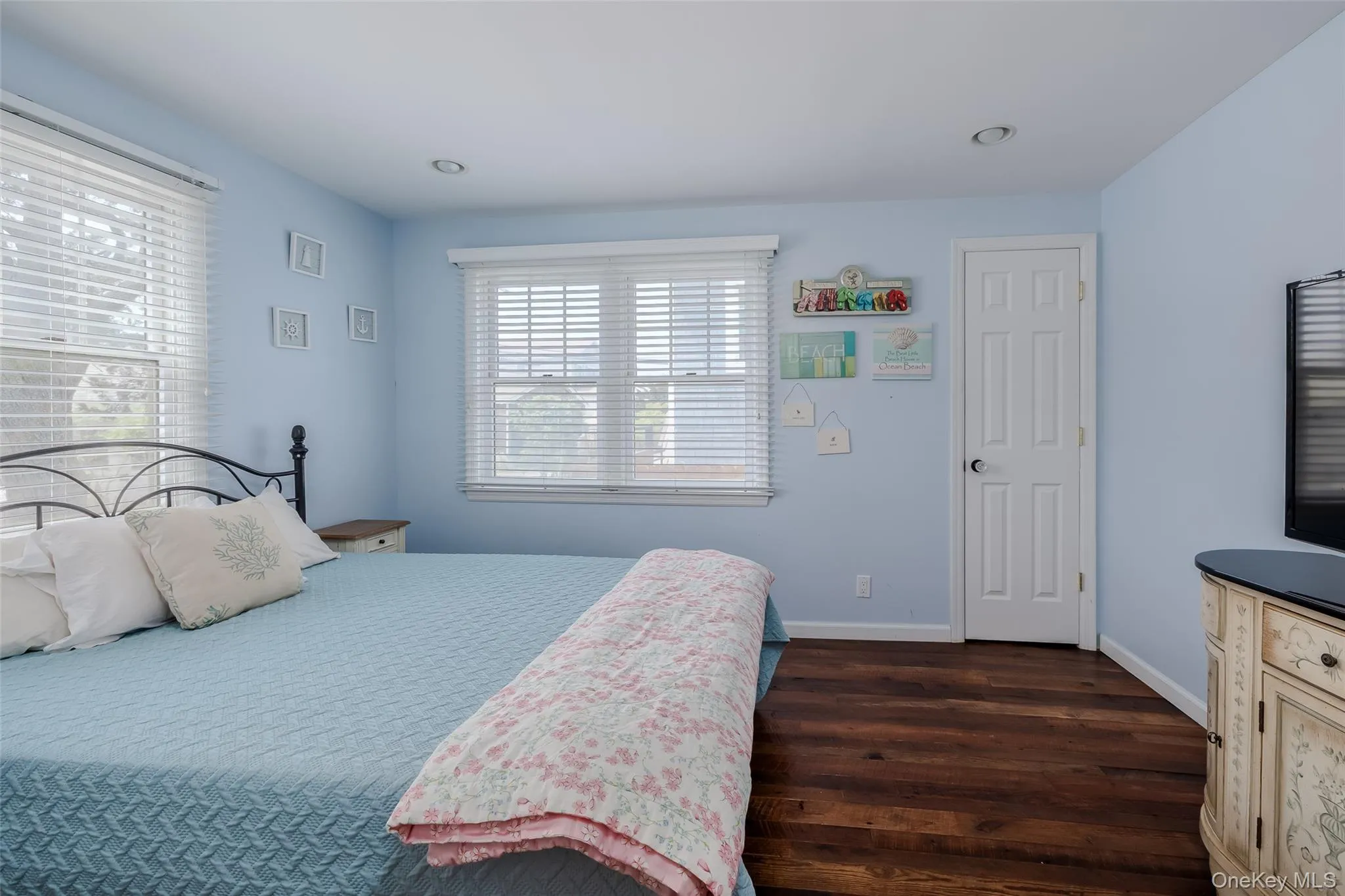 Bedroom with dark wood-type flooring and recessed lighting Bedroom with dark wood-type flooring and recessed lighting