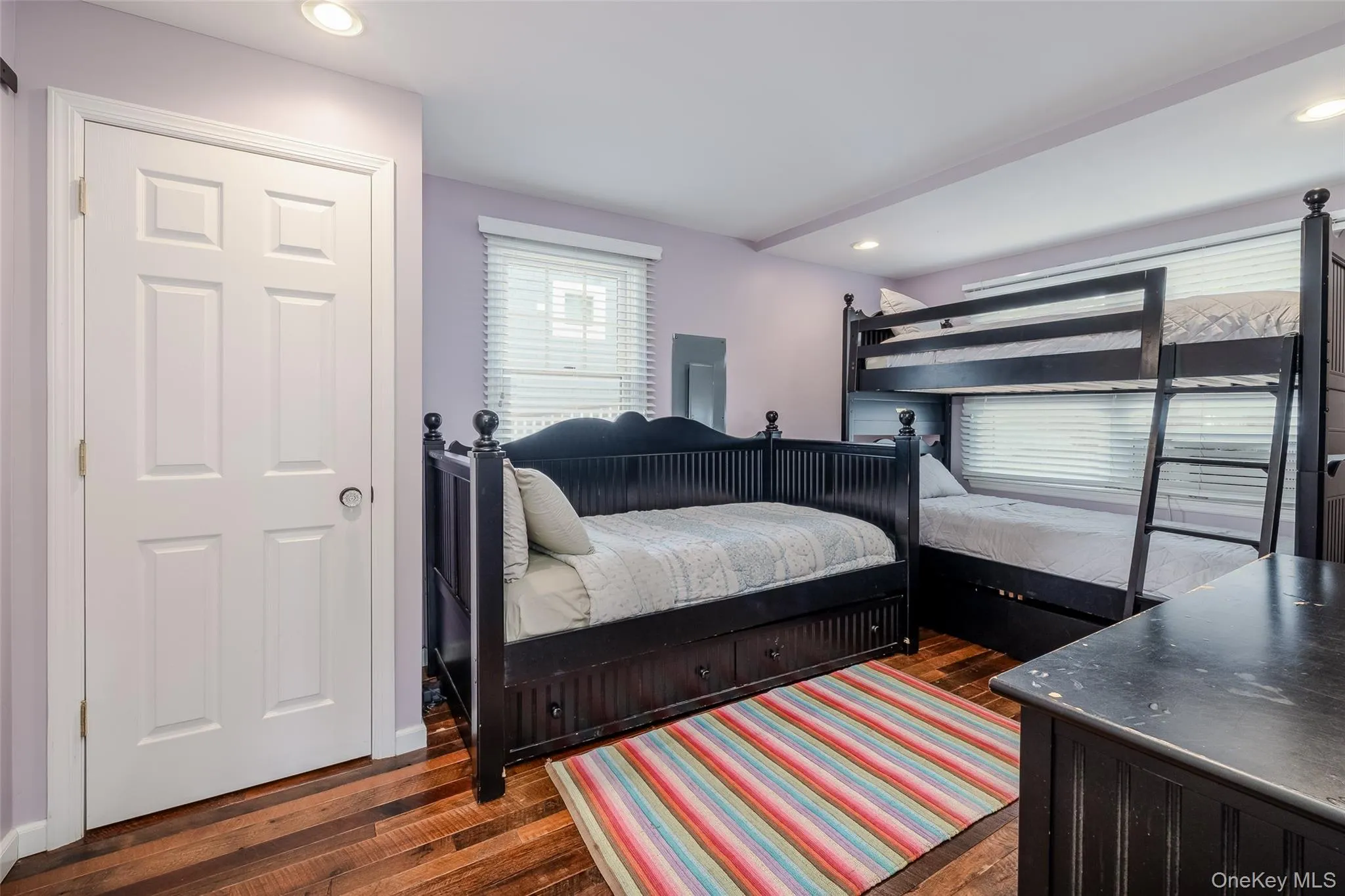 Bedroom featuring dark wood-style floors, recessed lighting, and electric panel Bedroom featuring dark wood-style floors, recessed lighting, and electric panel