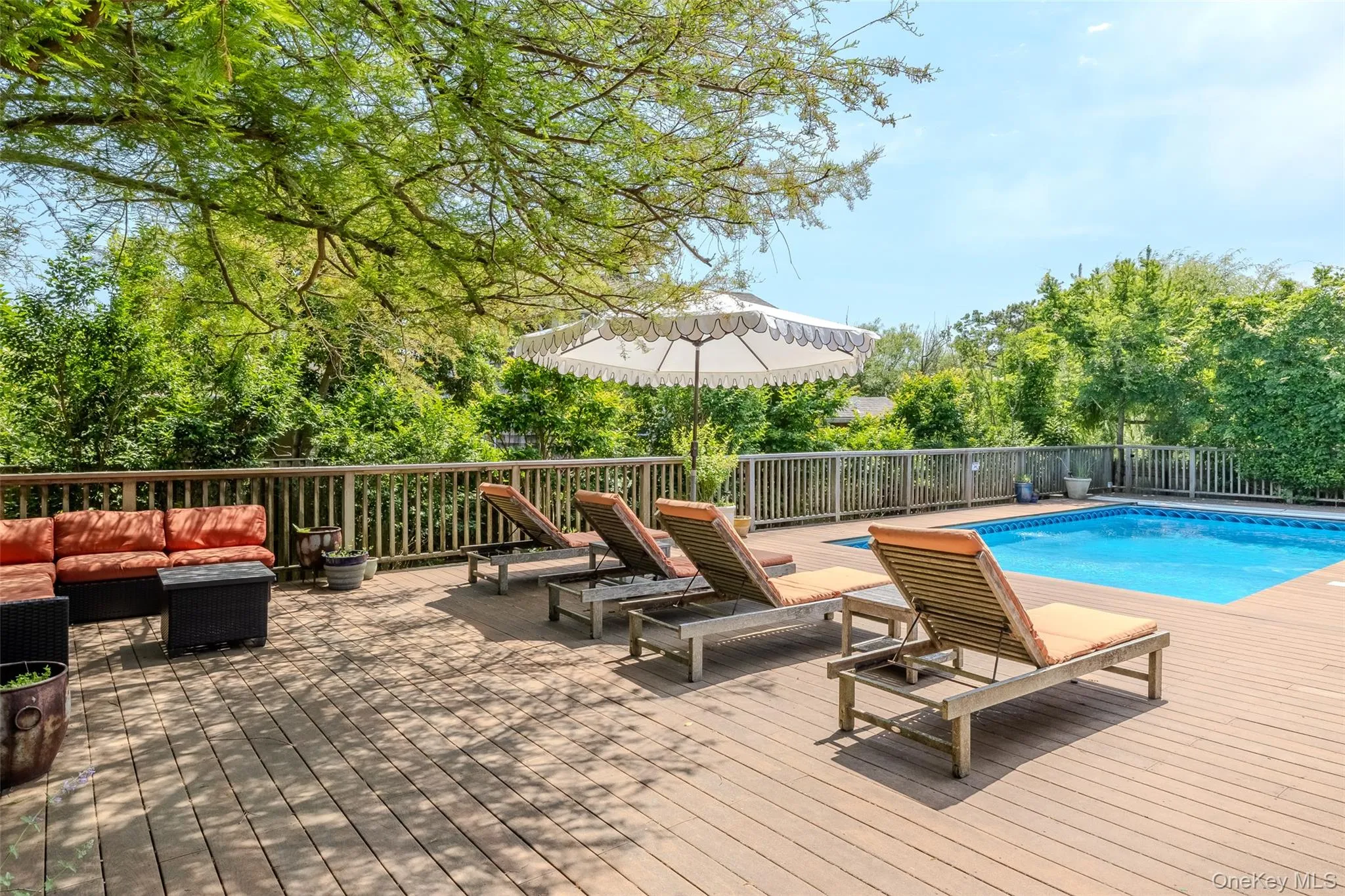View of swimming pool with an outdoor living space and a wooden deck View of swimming pool with an outdoor living space and a wooden deck