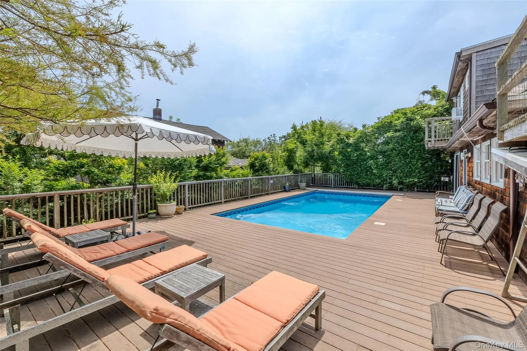 View of pool with a wooden deck View of pool with a wooden deck