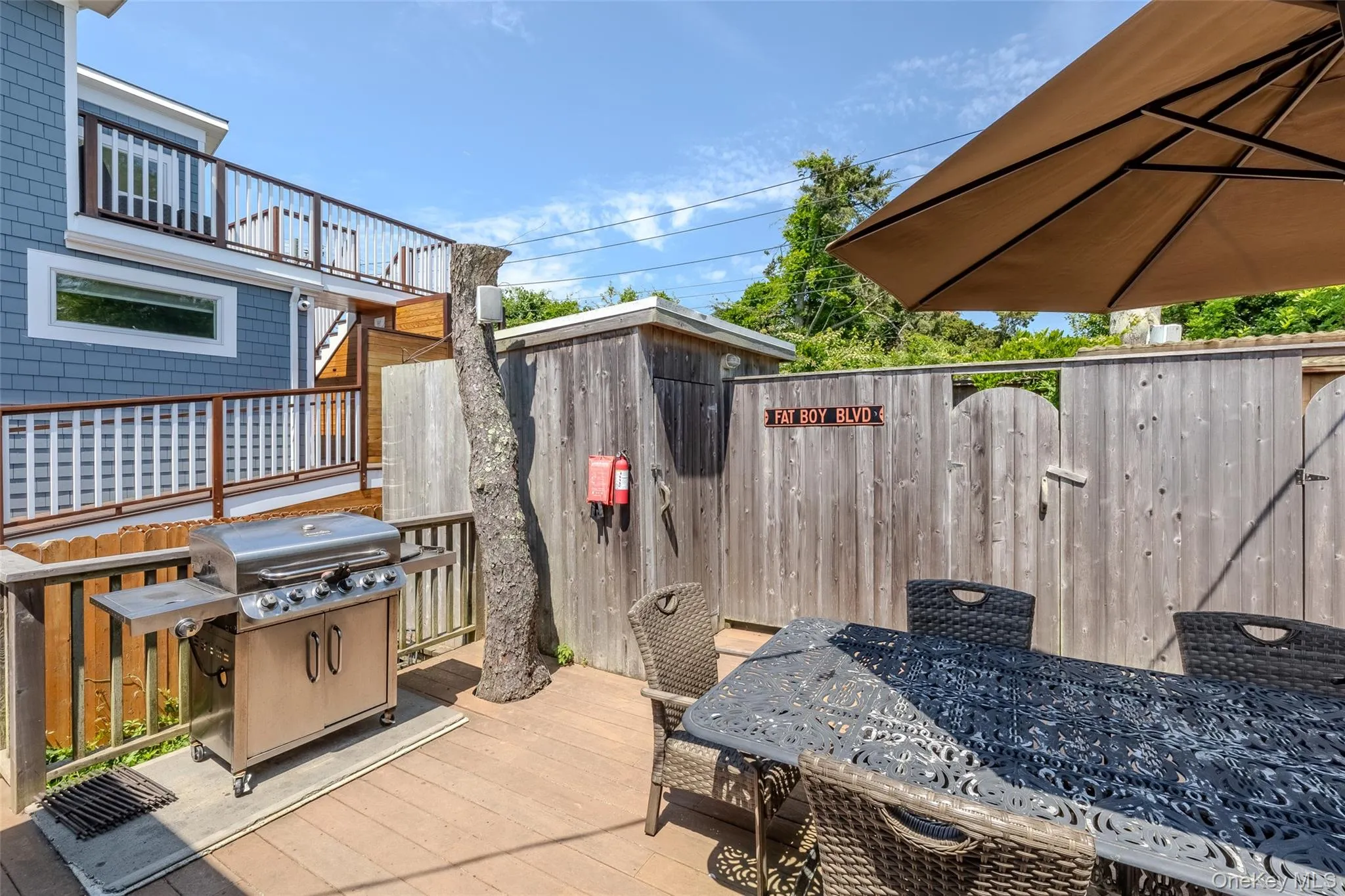 Wooden deck with grilling area and outdoor dining area Wooden deck with grilling area and outdoor dining area