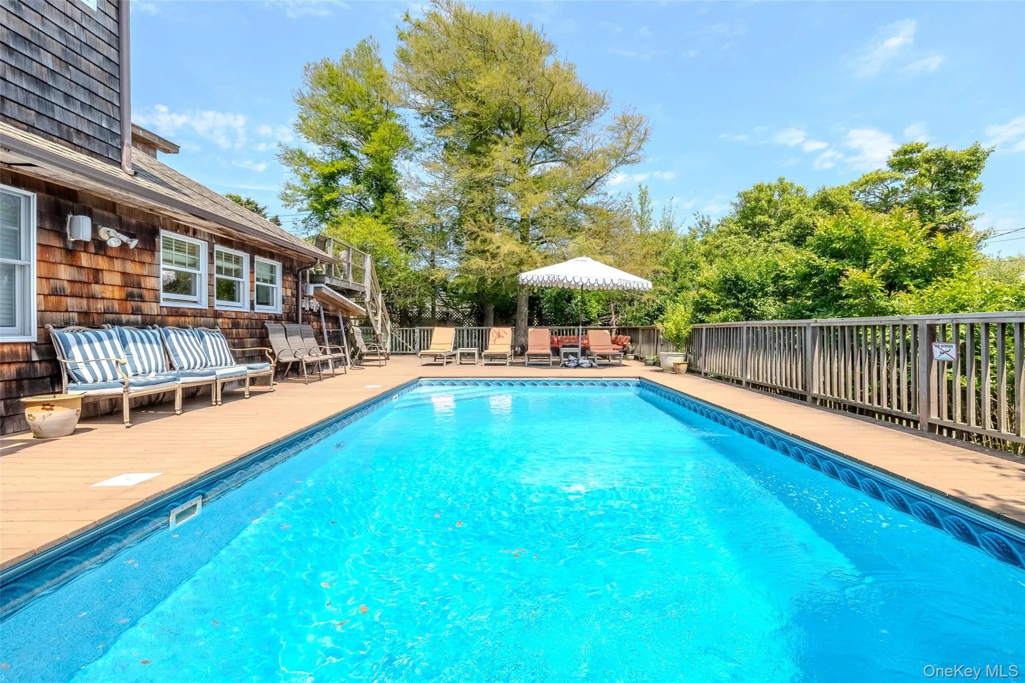 View of pool featuring an outdoor hangout area and a patio area View of pool featuring an outdoor hangout area and a patio area