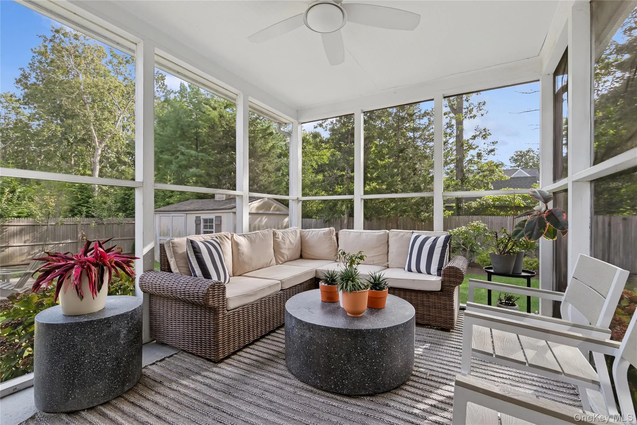 Sunroom with healthy amount of natural light, a ceiling fan, and outdoor lounge area Sunroom with healthy amount of natural light, a ceiling fan, and outdoor lounge area