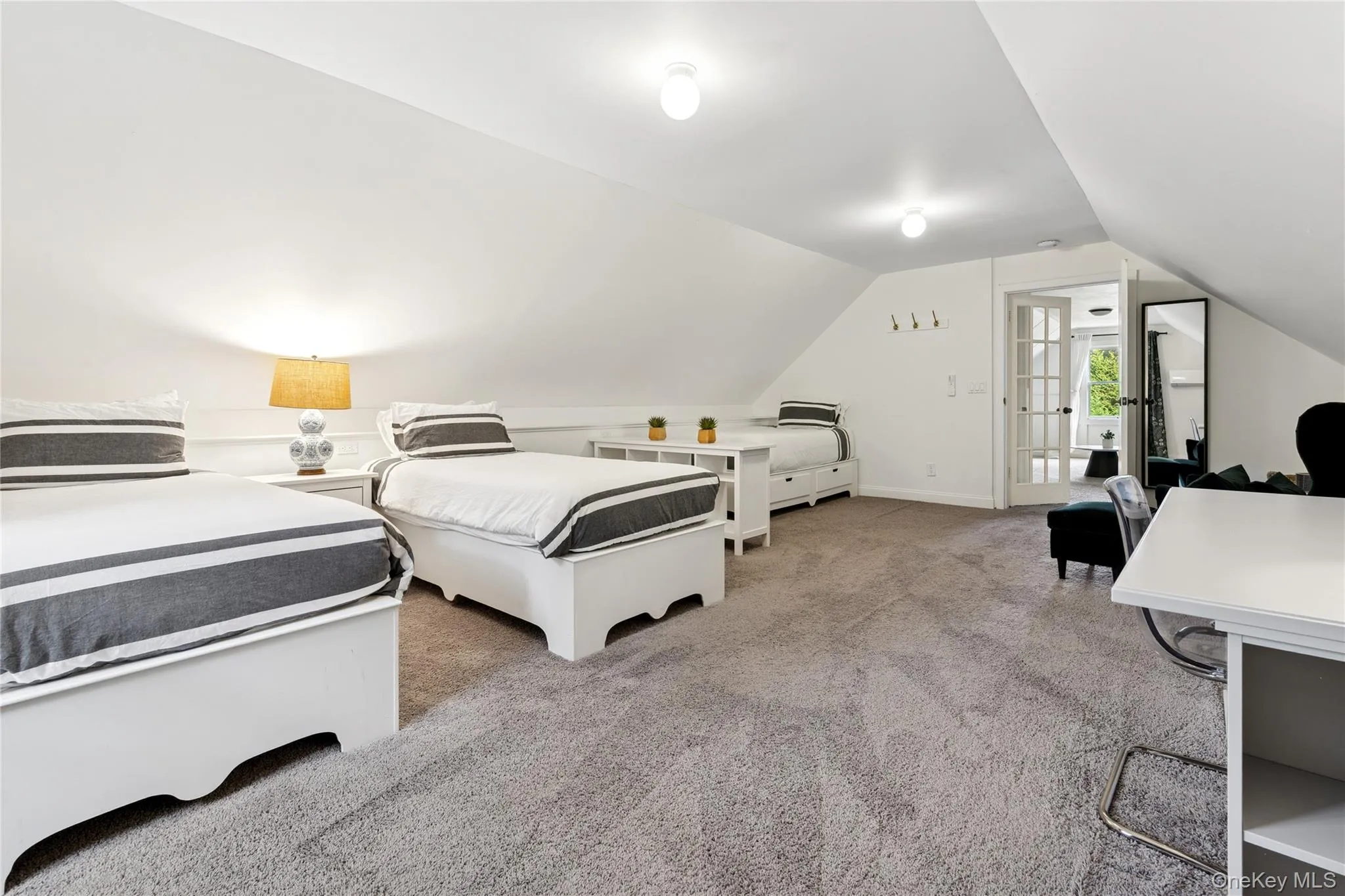 Bedroom featuring light carpet and lofted ceiling Bedroom featuring light carpet and lofted ceiling