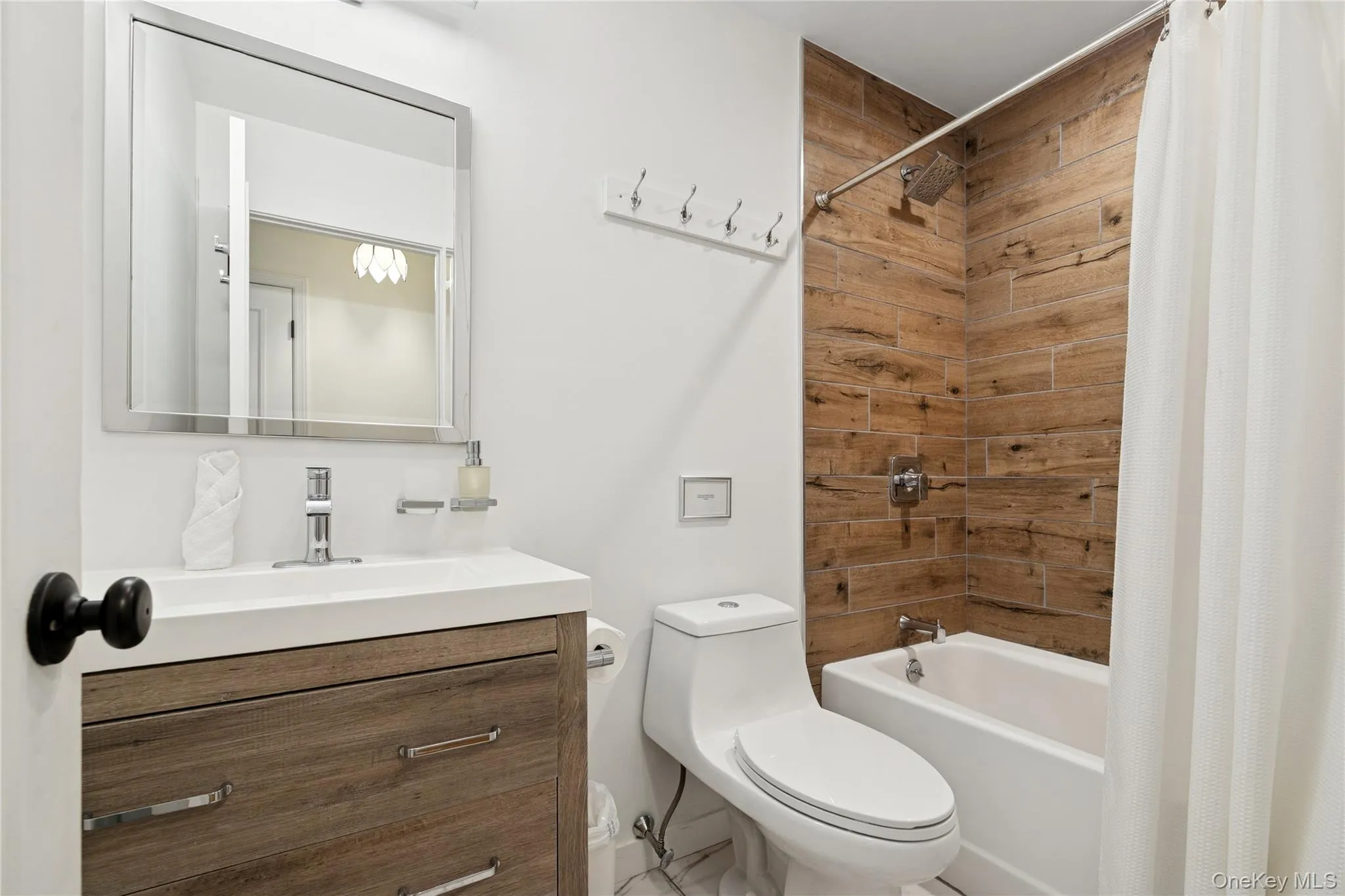 Full bathroom featuring shower / tub combo with curtain and vanity Full bathroom featuring shower / tub combo with curtain and vanity