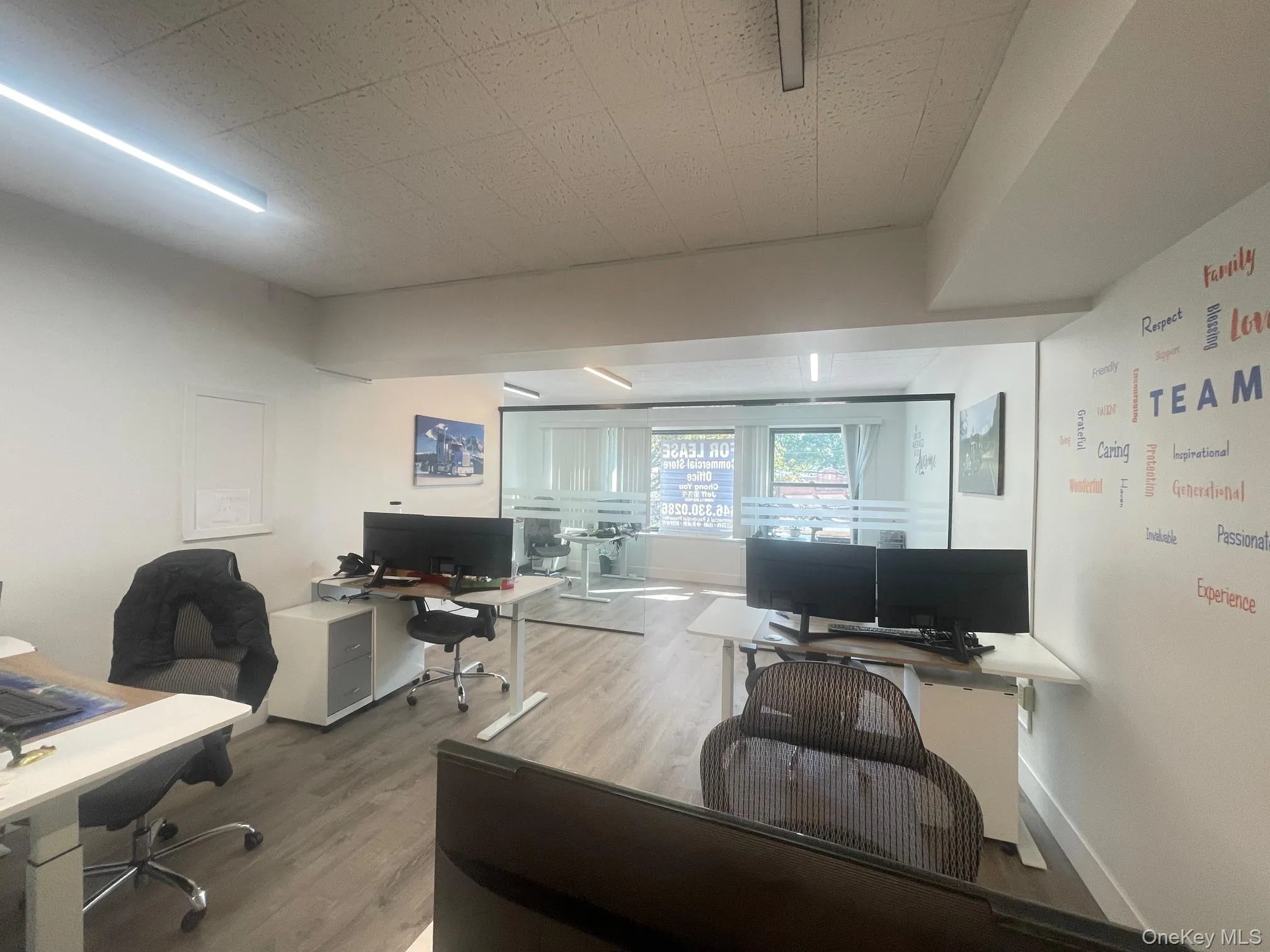 Office space with wood finished floors and baseboards Office space with wood finished floors and baseboards