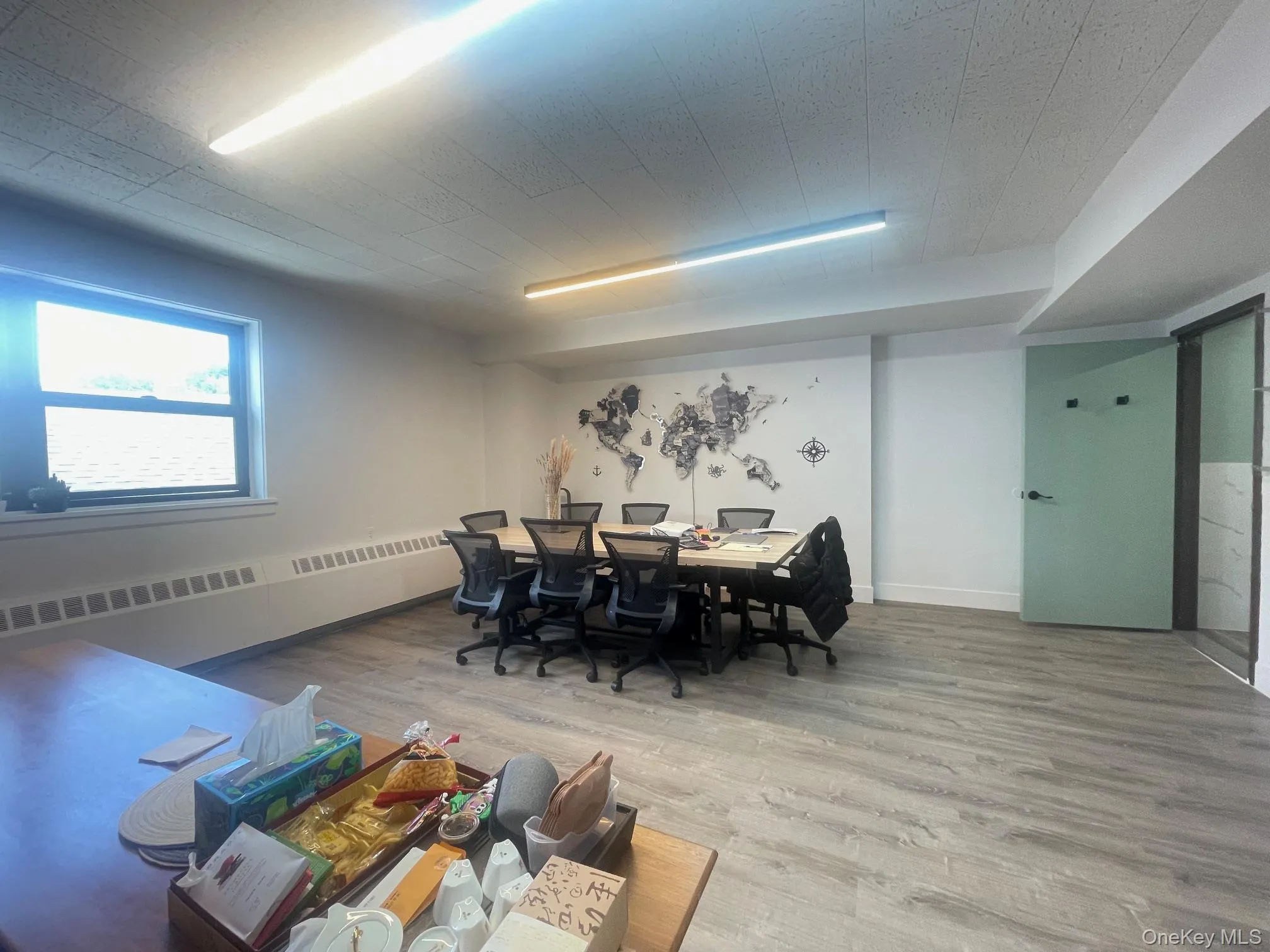 Dining room with wood finished floors and radiator Dining room with wood finished floors and radiator