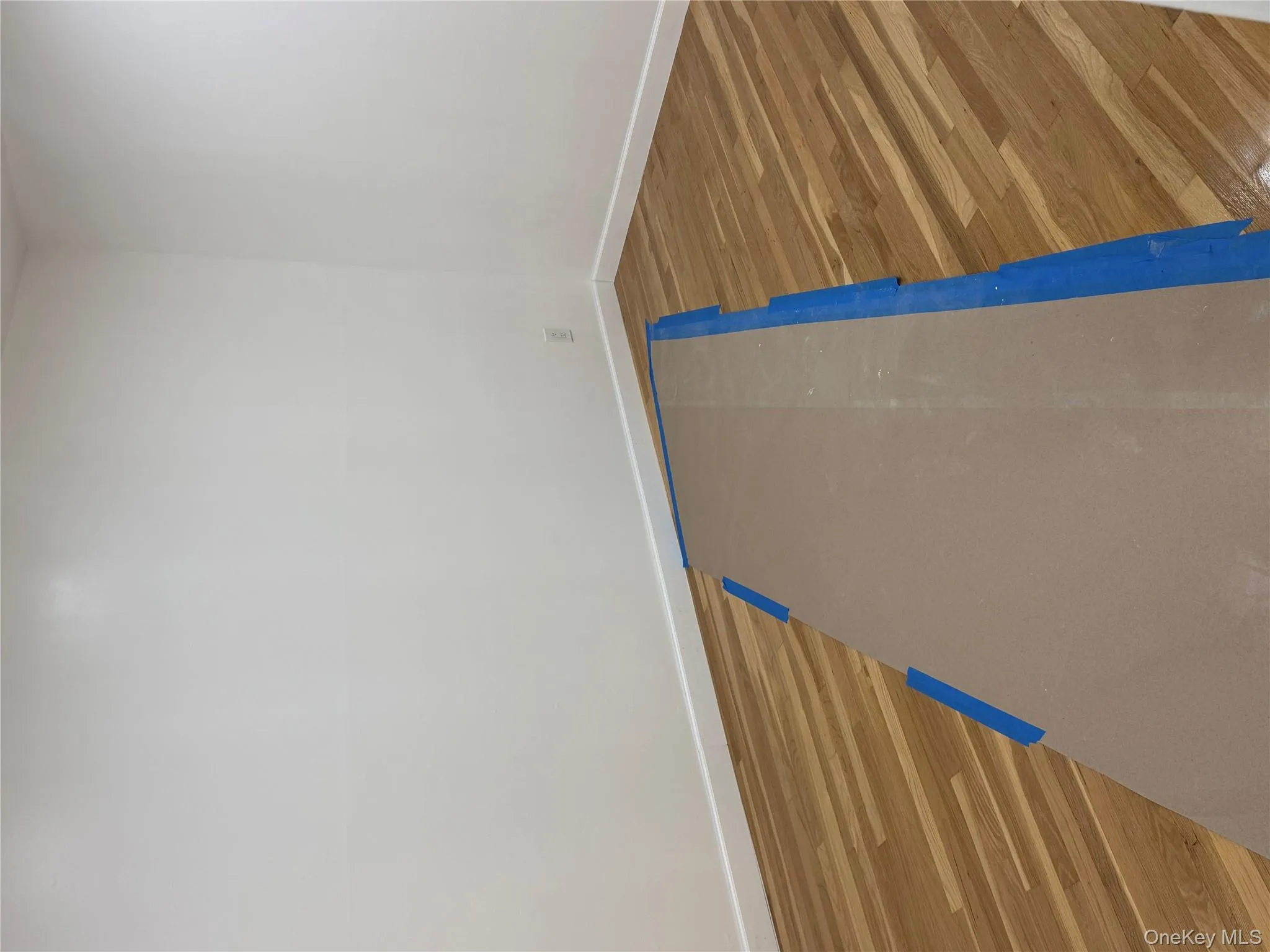 Empty room featuring baseboards and wood finished floors Empty room featuring baseboards and wood finished floors