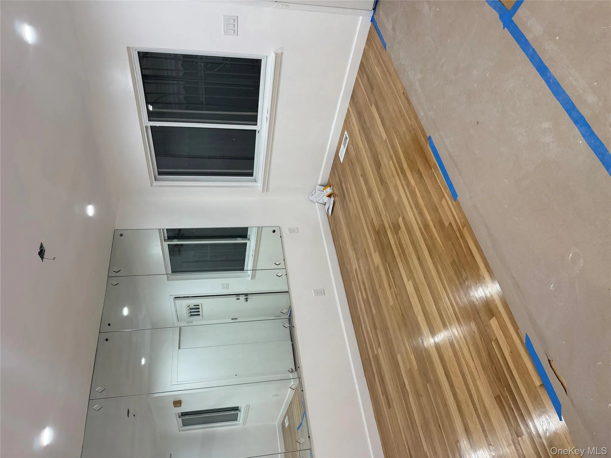 Empty room with recessed lighting and wood finished floors Empty room with recessed lighting and wood finished floors