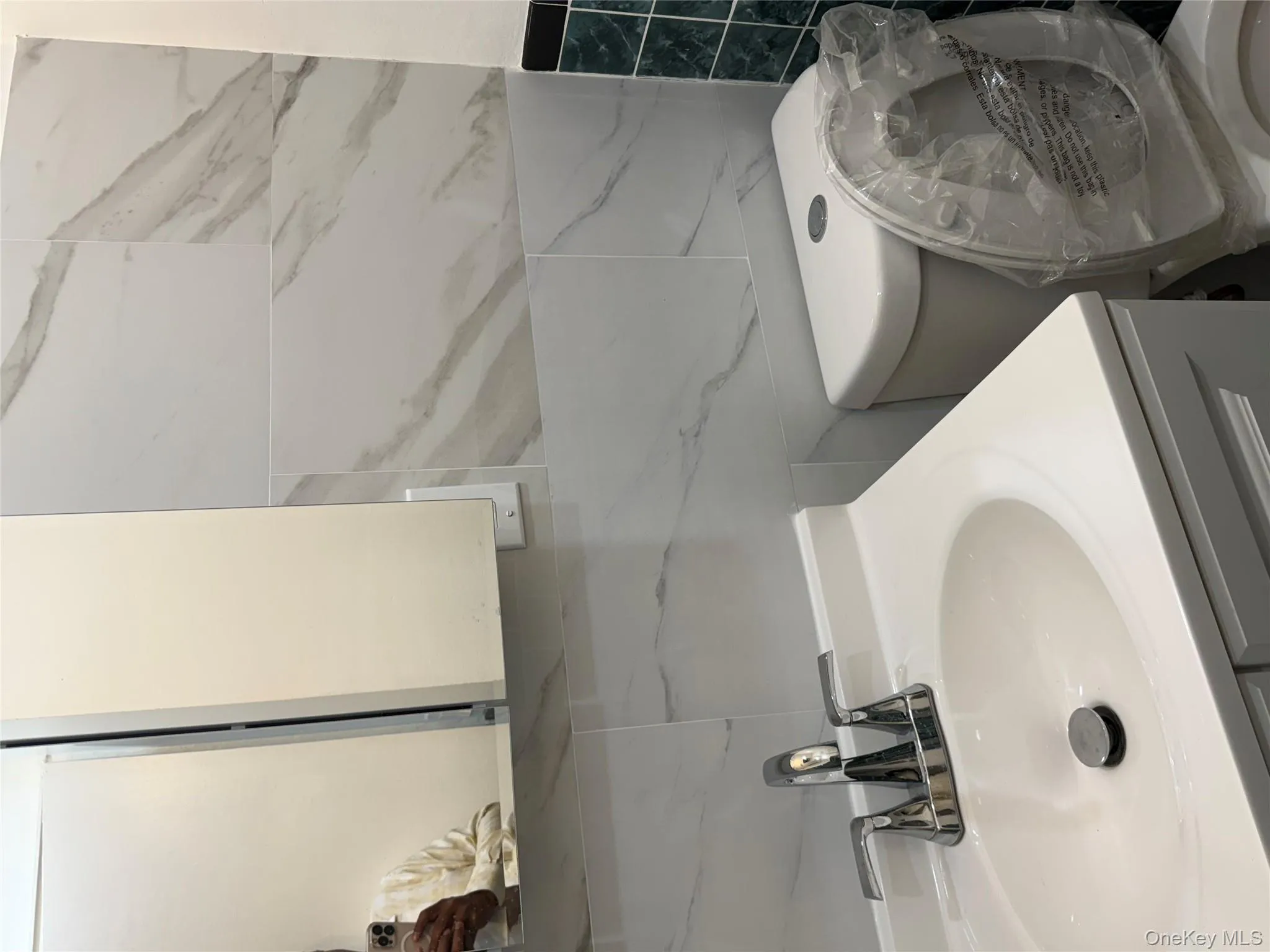 Half bath featuring vanity and tile walls Half bath featuring vanity and tile walls