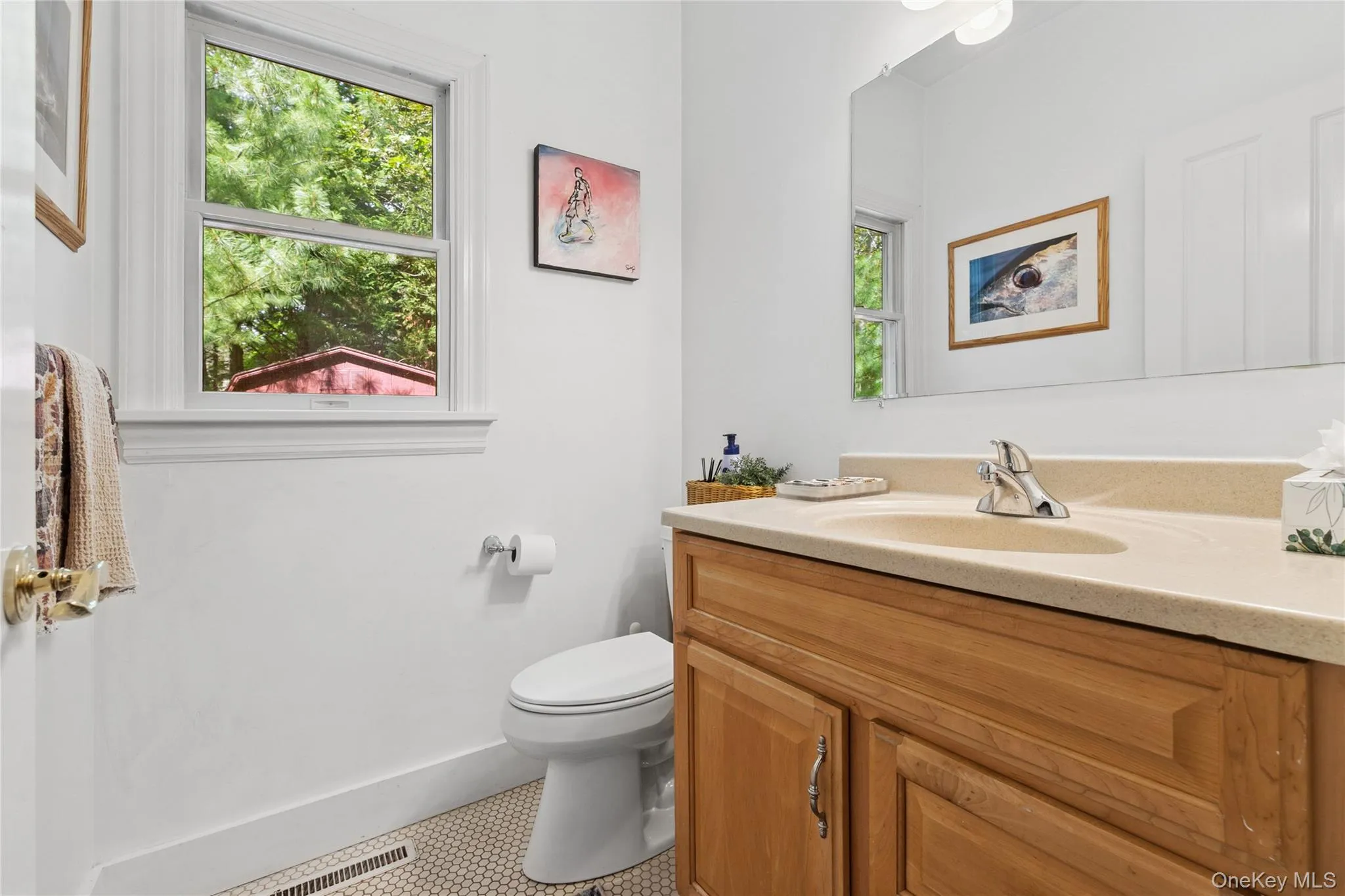 Half bathroom with vanity and light tile patterned floors Half bathroom with vanity and light tile patterned floors