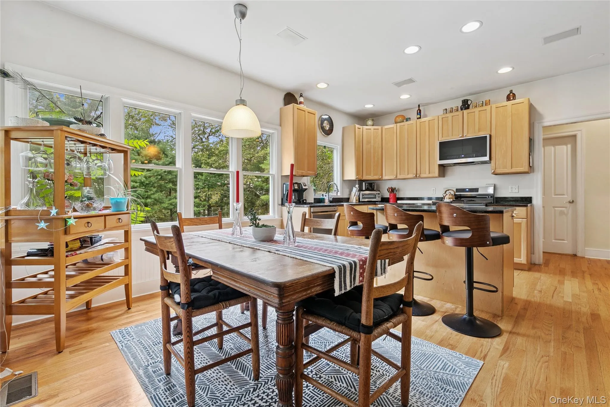 Dining space with light wood-style floors and recessed lighting Dining space with light wood-style floors and recessed lighting