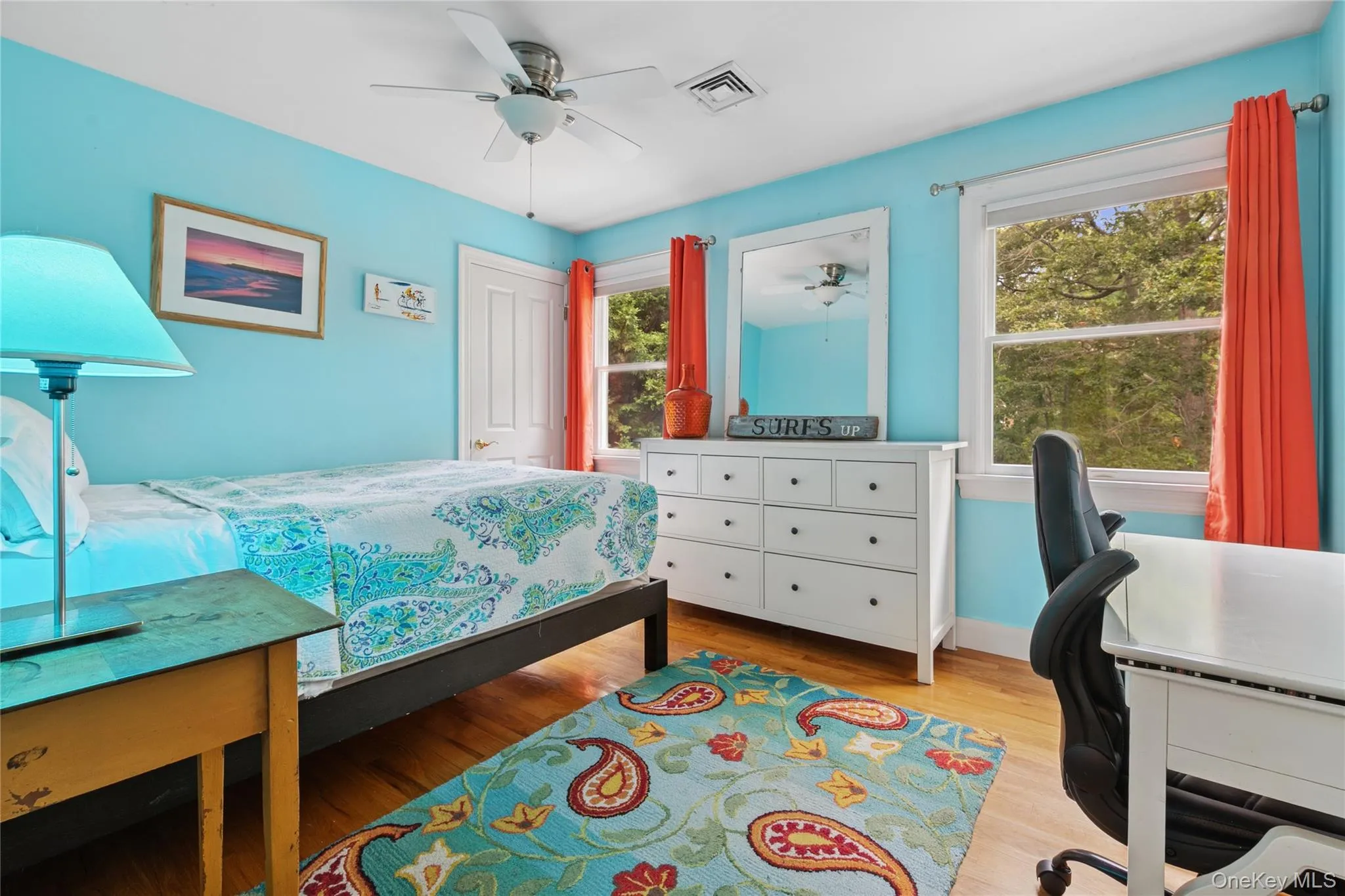 Bedroom featuring light wood-style flooring, ceiling fan, and an office area Bedroom featuring light wood-style flooring, ceiling fan, and an office area