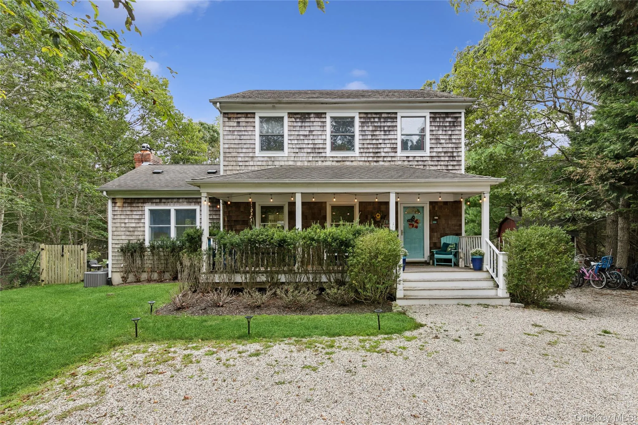 View of front of home with covered porch, a chimney, roof with shingles, and a front lawn View of front of home with covered porch, a chimney, roof with shingles, and a front lawn