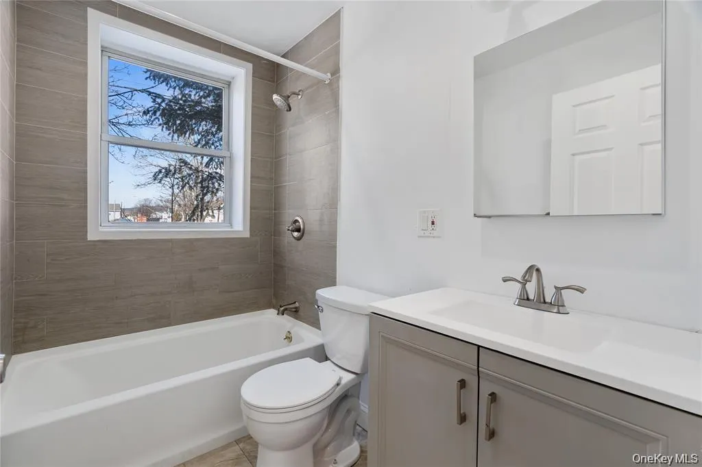 Full bath featuring vanity and shower / bath combination Full bath featuring vanity and shower / bath combination