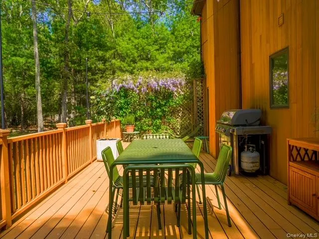 Wooden deck with grilling area and outdoor dining area Wooden deck with grilling area and outdoor dining area