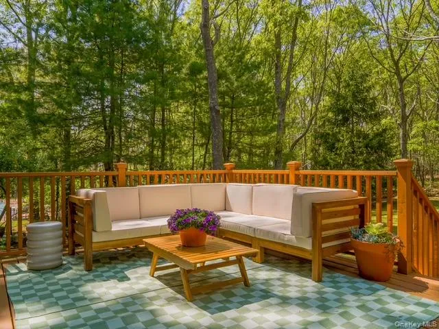 Deck with an outdoor living space and view of scattered trees Deck with an outdoor living space and view of scattered trees