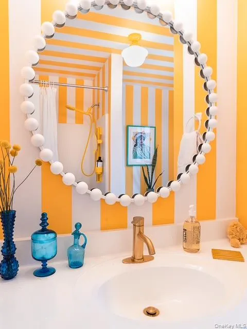 Bathroom view of a shower with curtain and vanity Bathroom view of a shower with curtain and vanity