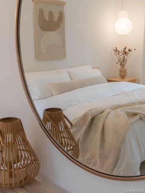 Bedroom featuring wood finished floors and a nursery area Bedroom featuring wood finished floors and a nursery area