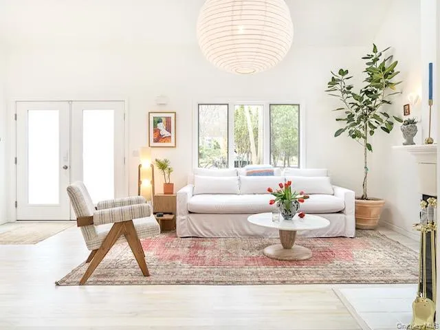 Living room featuring french doors and wood finished floors Living room featuring french doors and wood finished floors
