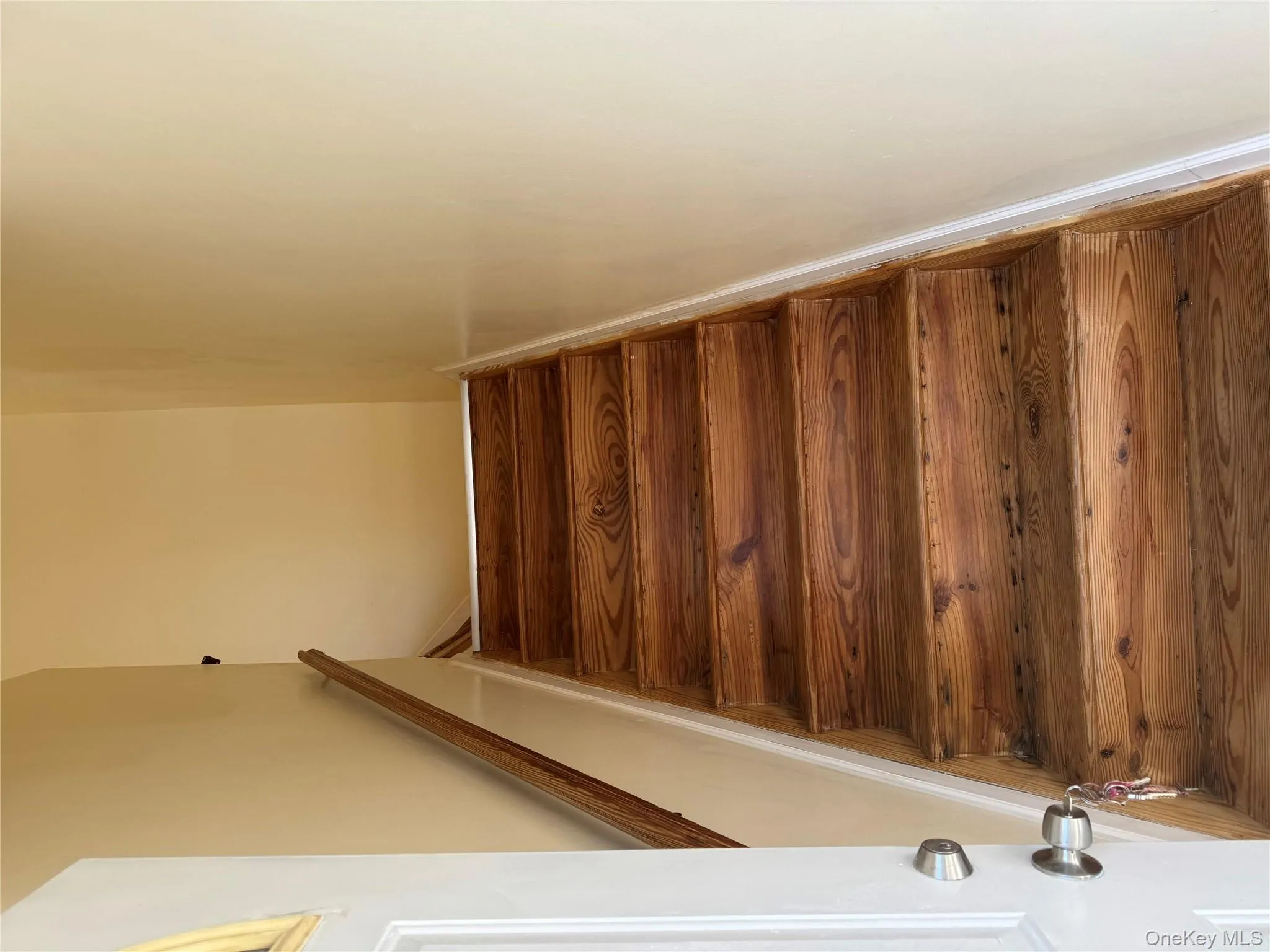 Staircase featuring hardwood / wood-style floors Staircase featuring hardwood / wood-style floors