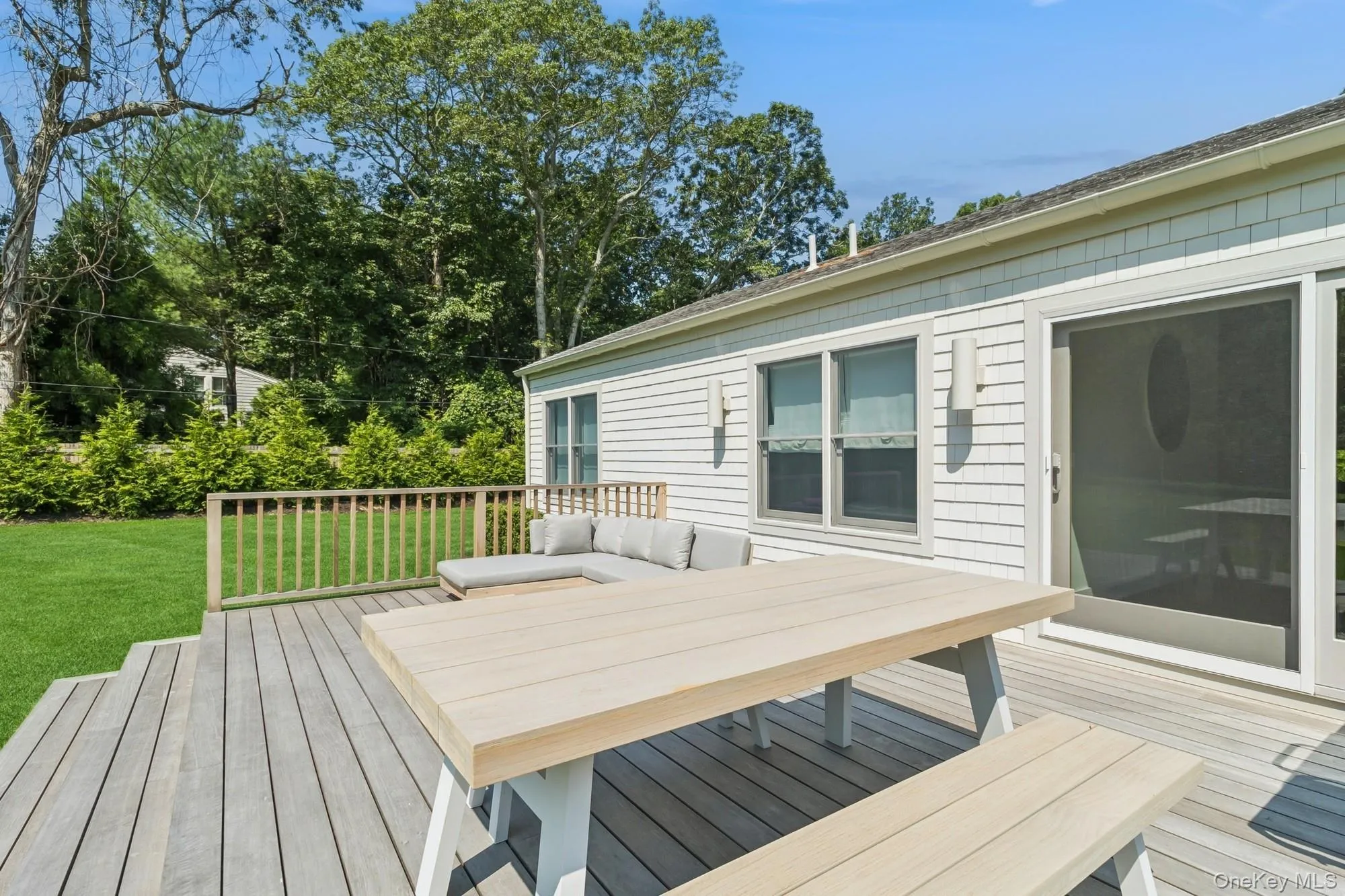 Wooden deck featuring a yard, an outdoor hangout area, view of scattered trees, and outdoor dining area Wooden deck featuring a yard, an outdoor hangout area, view of scattered trees, and outdoor dining area