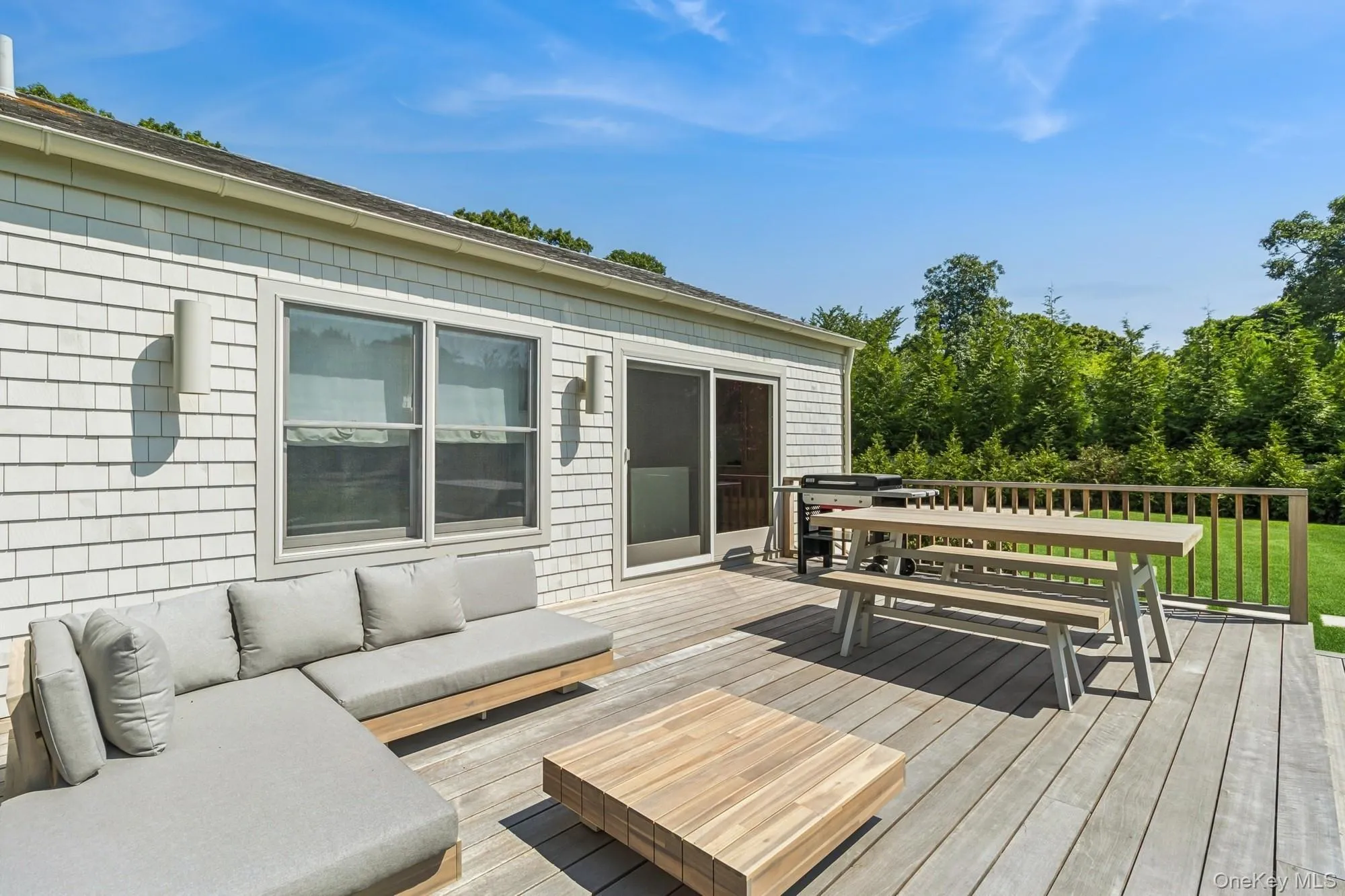 Wooden terrace with outdoor dining area and an outdoor living space Wooden terrace with outdoor dining area and an outdoor living space