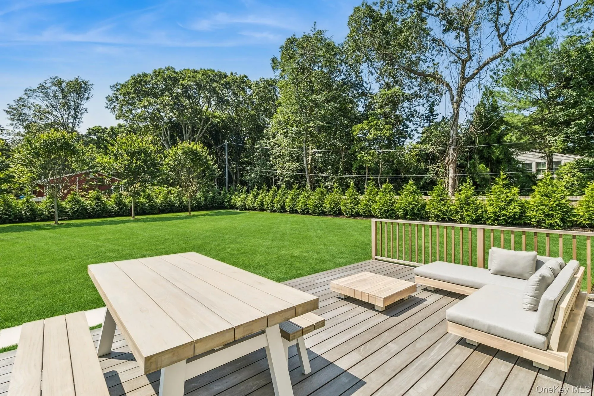 Wooden terrace featuring a yard and an outdoor hangout area Wooden terrace featuring a yard and an outdoor hangout area