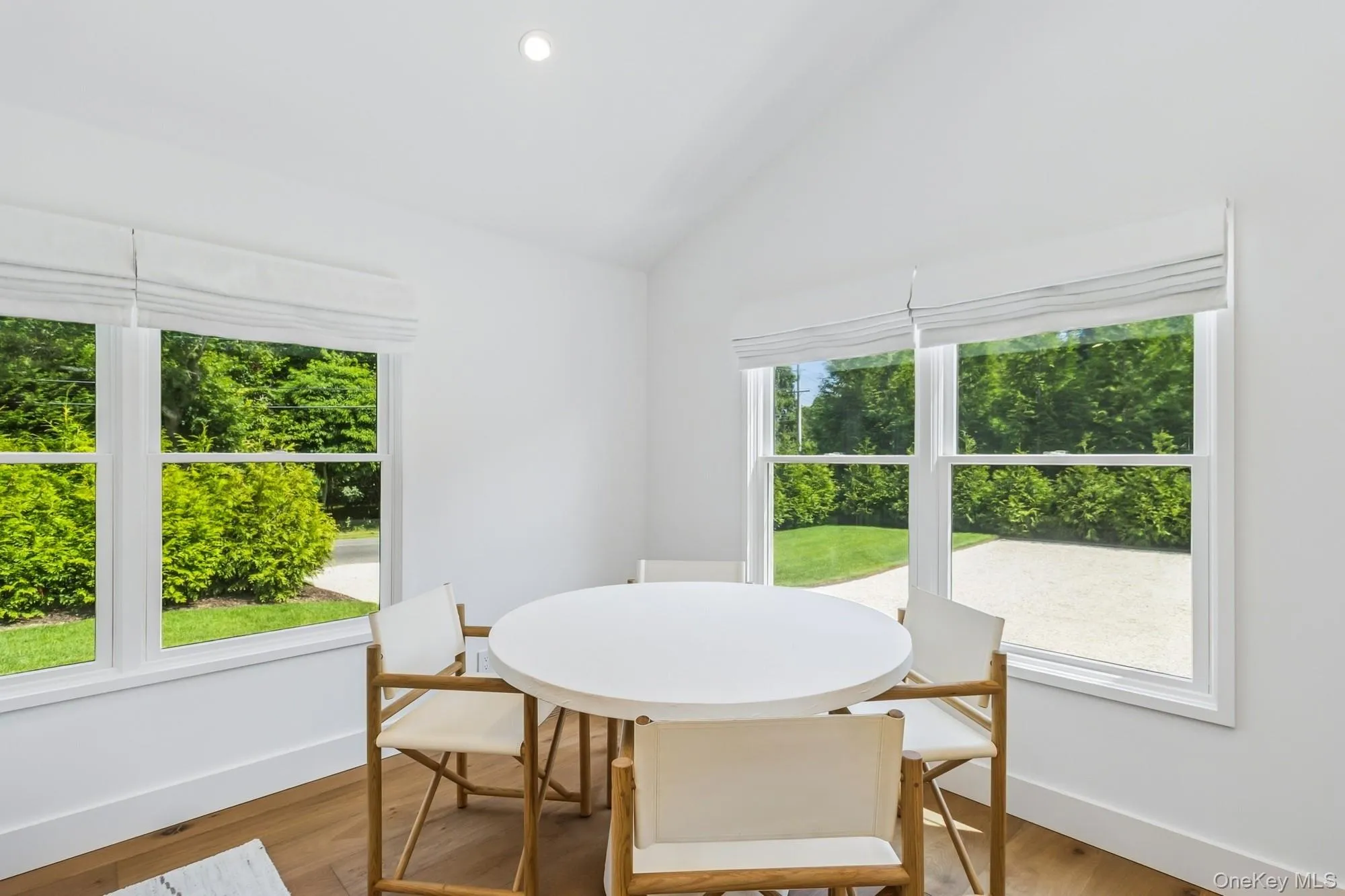 Dining space featuring vaulted ceiling, light wood-style floors, and recessed lighting Dining space featuring vaulted ceiling, light wood-style floors, and recessed lighting