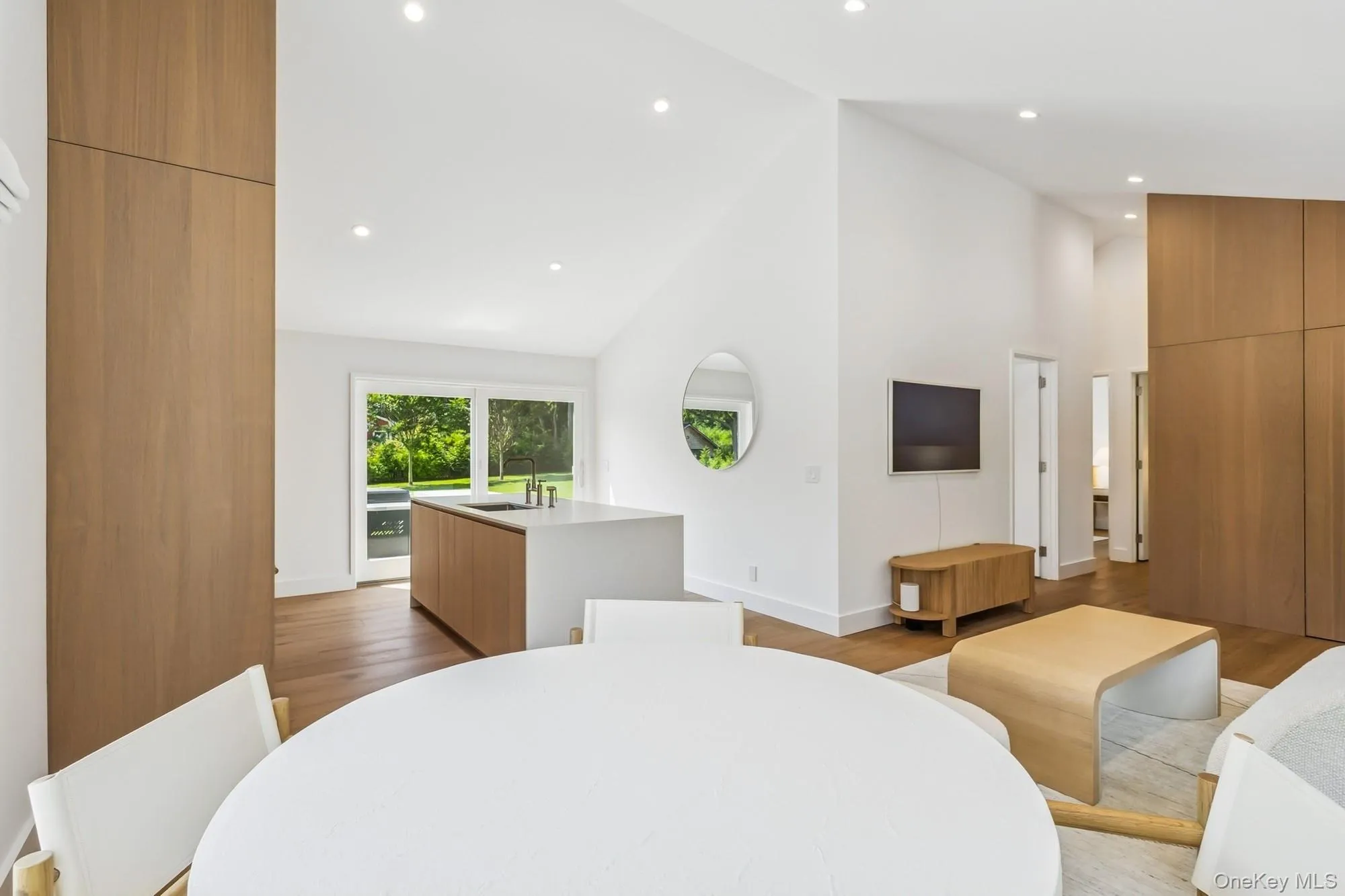 Bedroom with high vaulted ceiling, recessed lighting, and light wood-style floors Bedroom with high vaulted ceiling, recessed lighting, and light wood-style floors