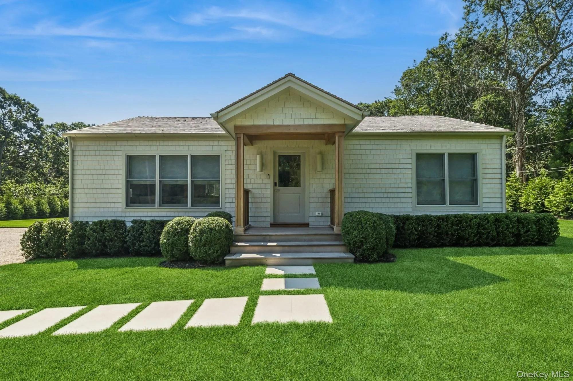 View of front of property featuring a front lawn, covered porch, and roof with shingles View of front of property featuring a front lawn, covered porch, and roof with shingles
