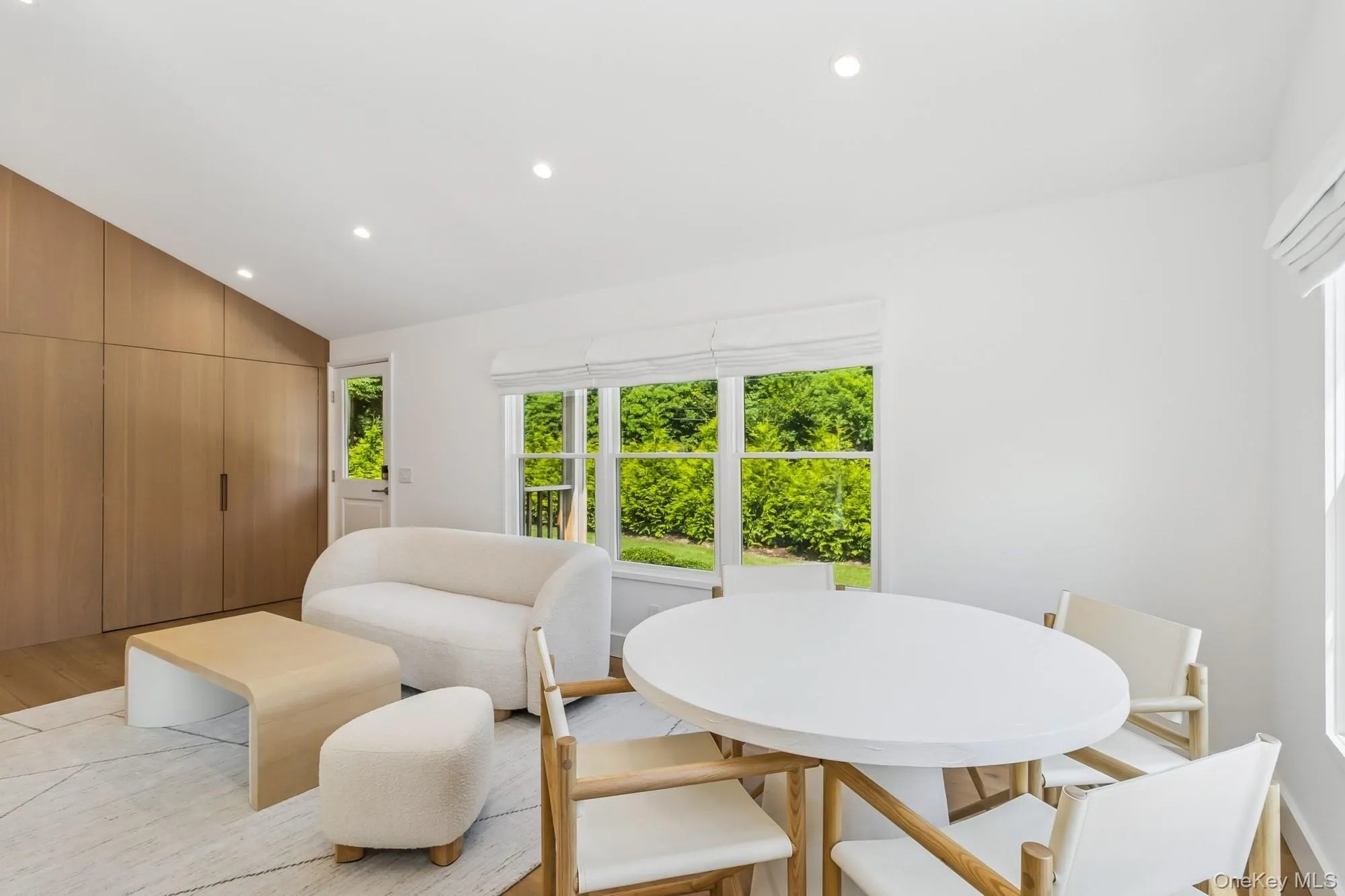 Dining room featuring vaulted ceiling, recessed lighting, and light wood-type flooring Dining room featuring vaulted ceiling, recessed lighting, and light wood-type flooring