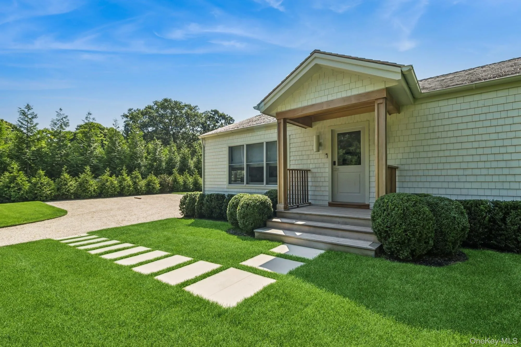 Doorway to property with a yard, gravel driveway, and roof with shingles Doorway to property with a yard, gravel driveway, and roof with shingles