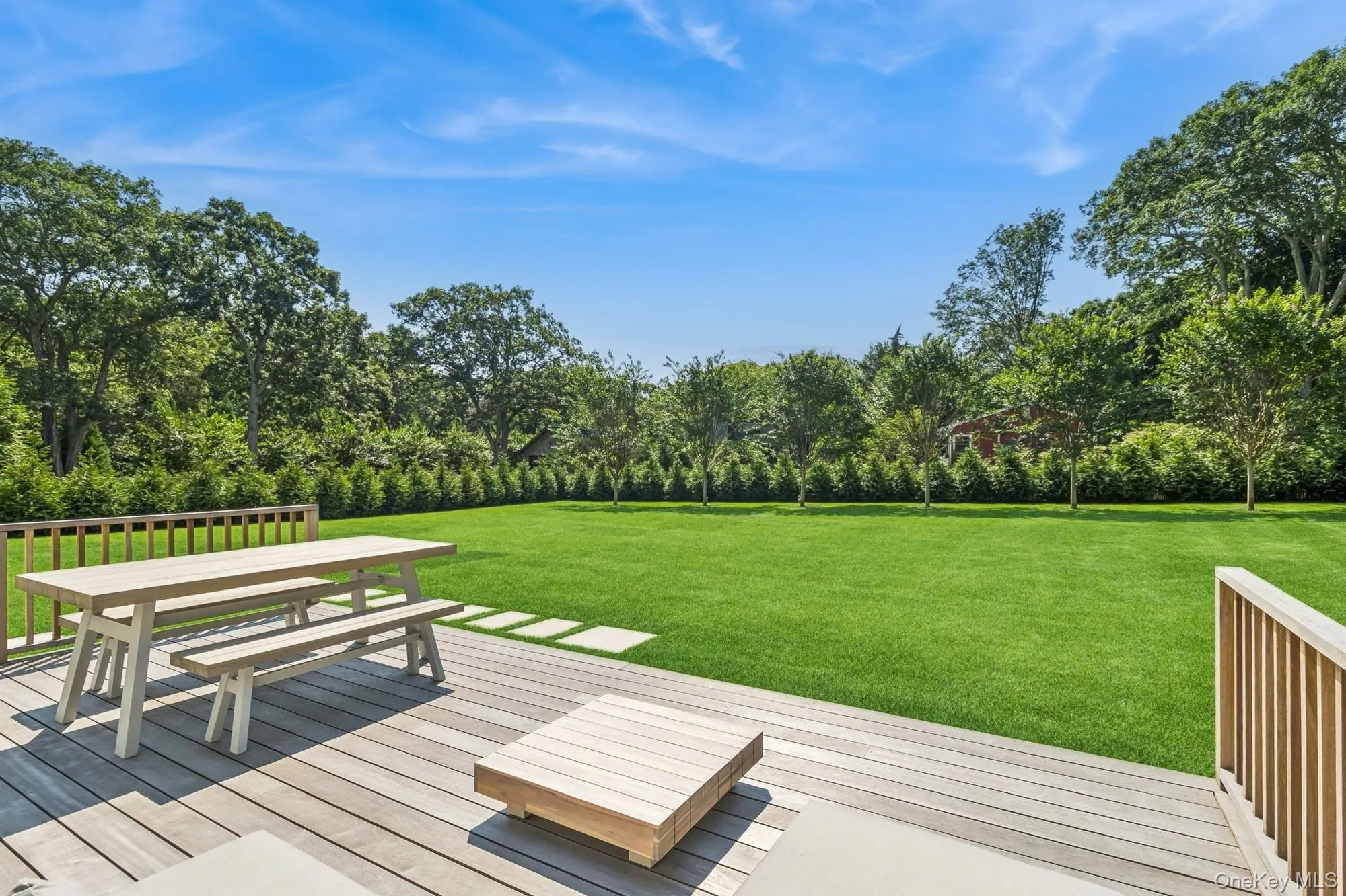 Deck with a lawn and outdoor dining area Deck with a lawn and outdoor dining area