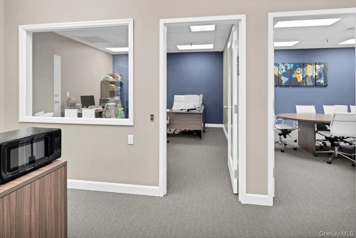 Office space featuring carpet floors and a drop ceiling Office space featuring carpet floors and a drop ceiling