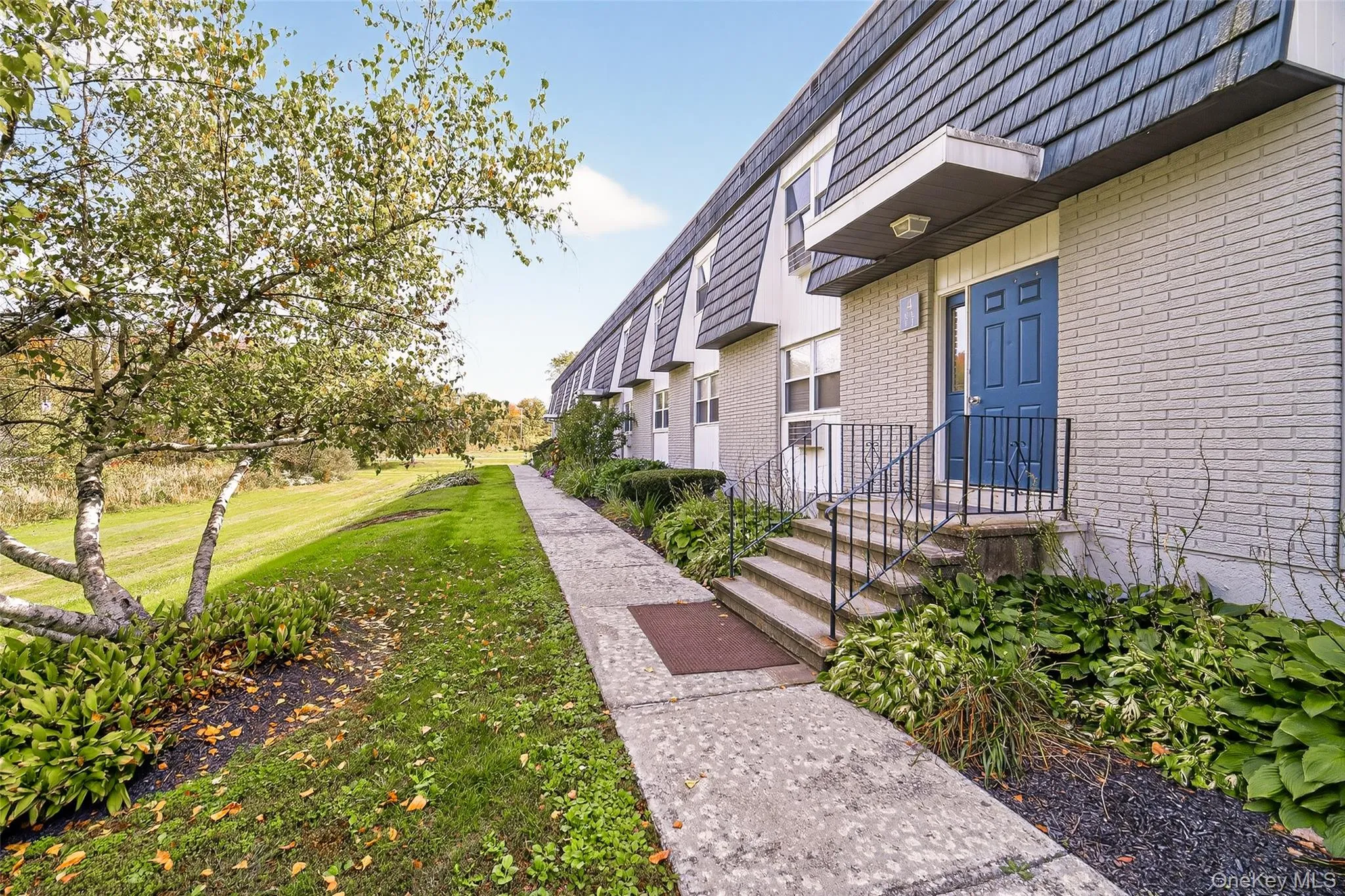 View of home's community with a lawn View of home's community with a lawn